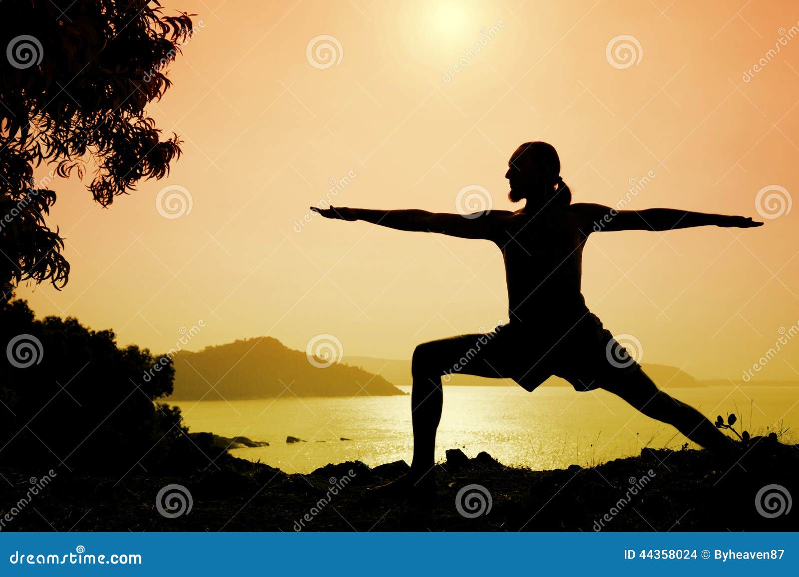 Ethnic man in sportswear doing yoga at sunset - a Royalty Free Stock Photo  from Photocase