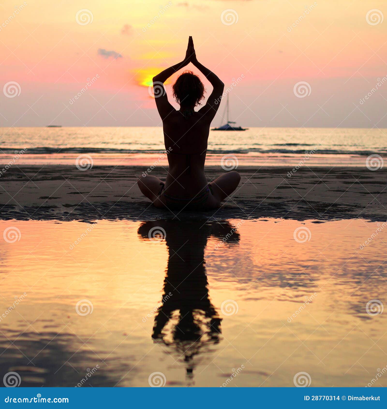 Yoga Pose At The Beach During Sunset Stock Photo