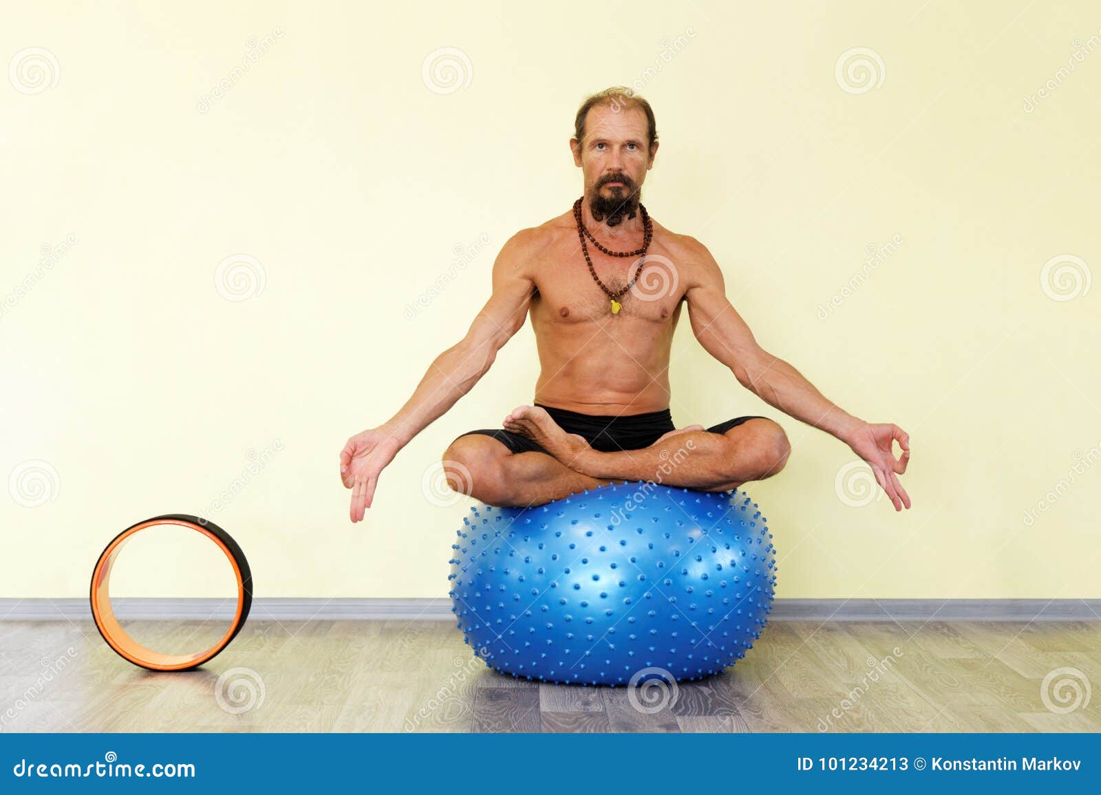 Yogi Man Practicing Yoga on Fitness Ball in Lotus Pose Stock Image