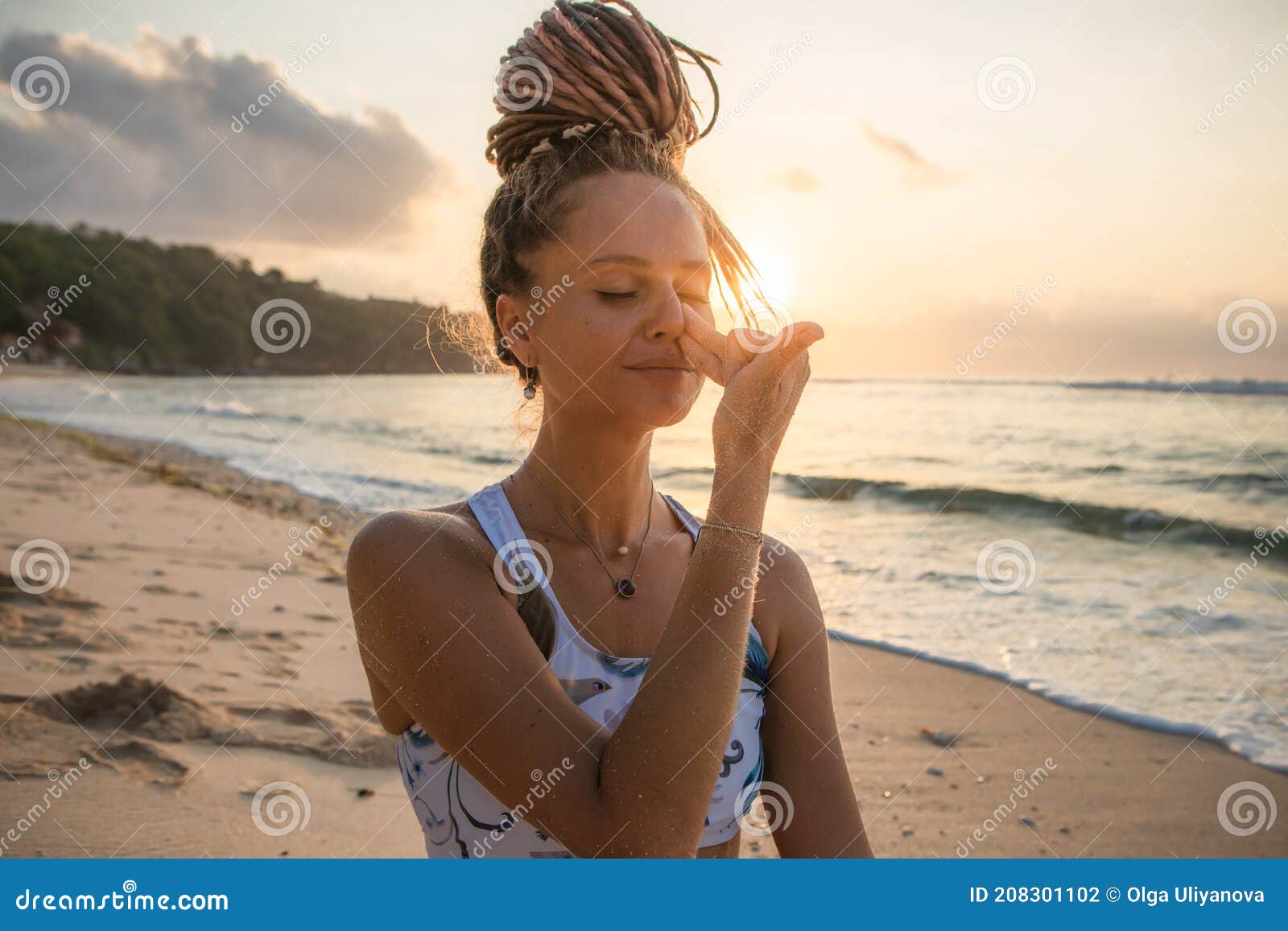 yogi woman practicing nadi shodhana pranayama, alternate nostril breathing. control prana, control of breath. breathing exercise.