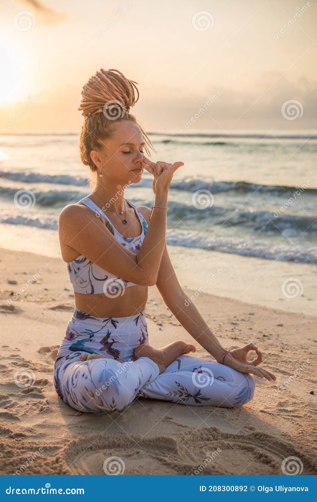 yogi woman sitting in lotus pose, practicing anuloma viloma pranayama, alternate nostril breathing. control prana, control of