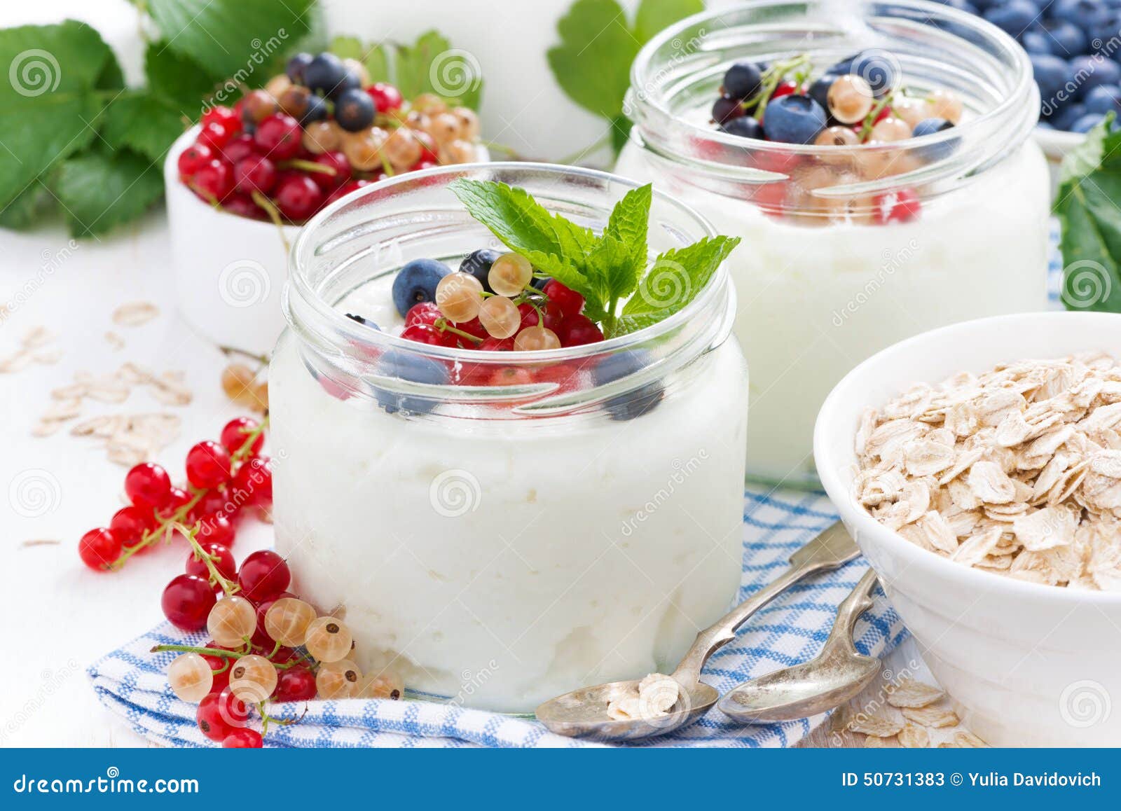 Yogurt with Fresh Berries and Breakfast Foods on Table Stock Image