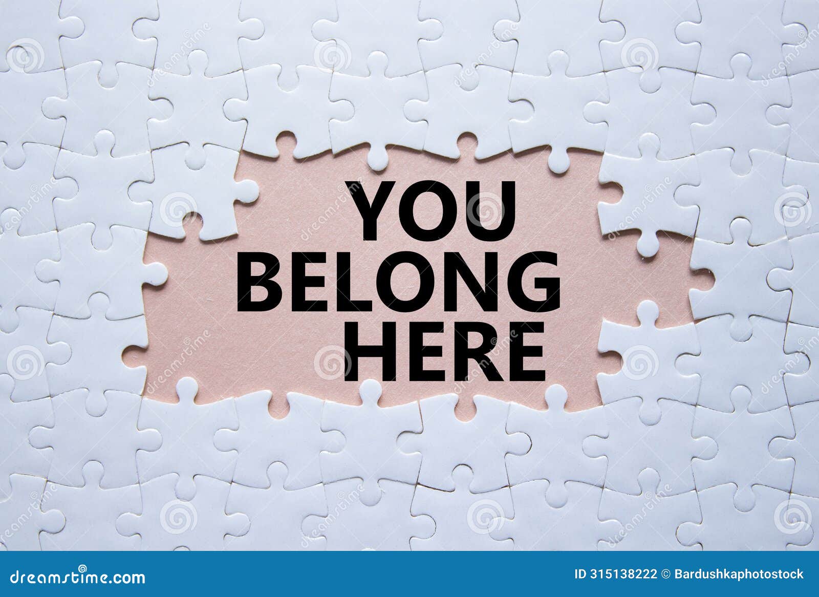 you belong here . white puzzle with words you belong here. beautiful pink background. business and you belong here concept.