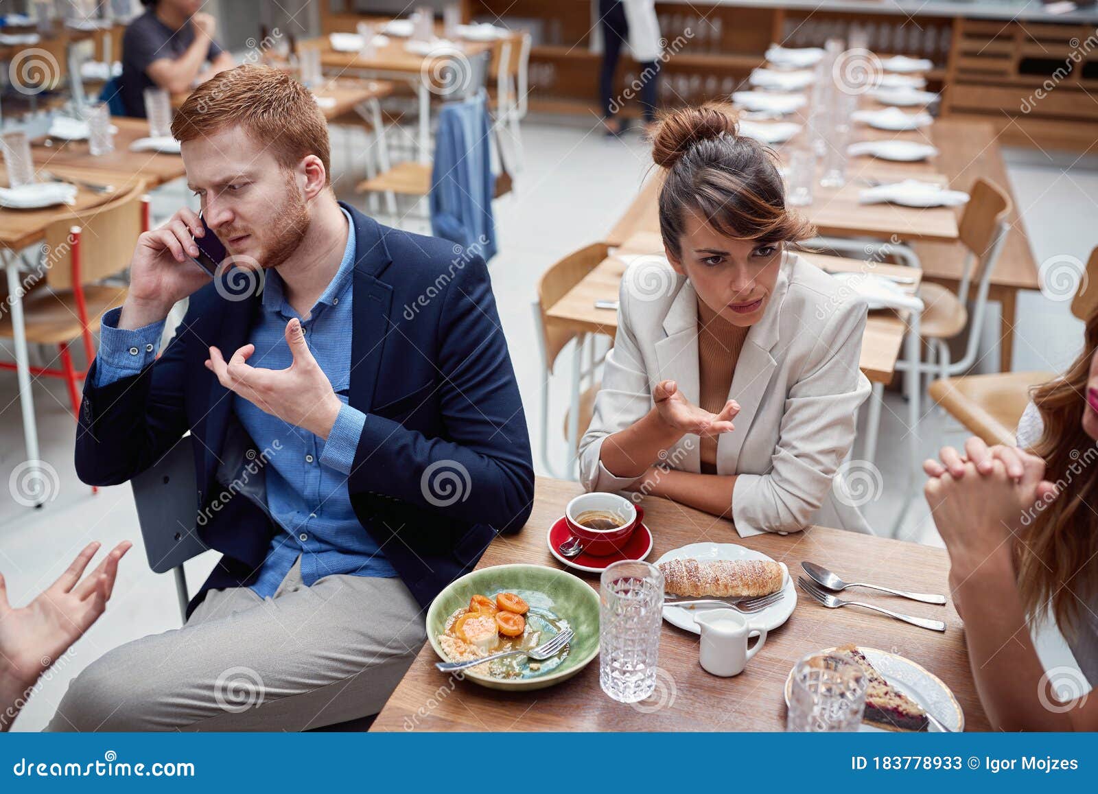 young adult businesspeople at lunch in a restaurant discussing about issues after coronavirus. recesion, economy, business