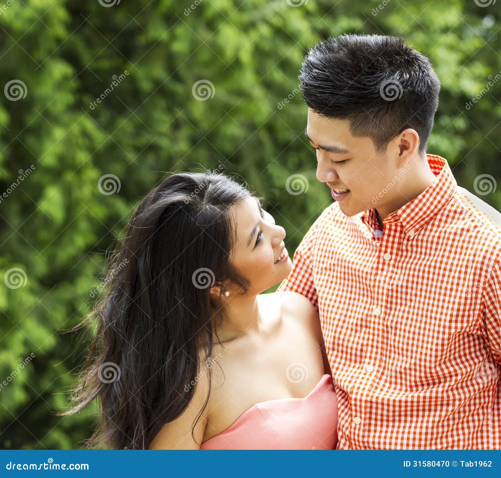 Young Adult Couple Sharing a Romantic Moment Outside Stock Photo