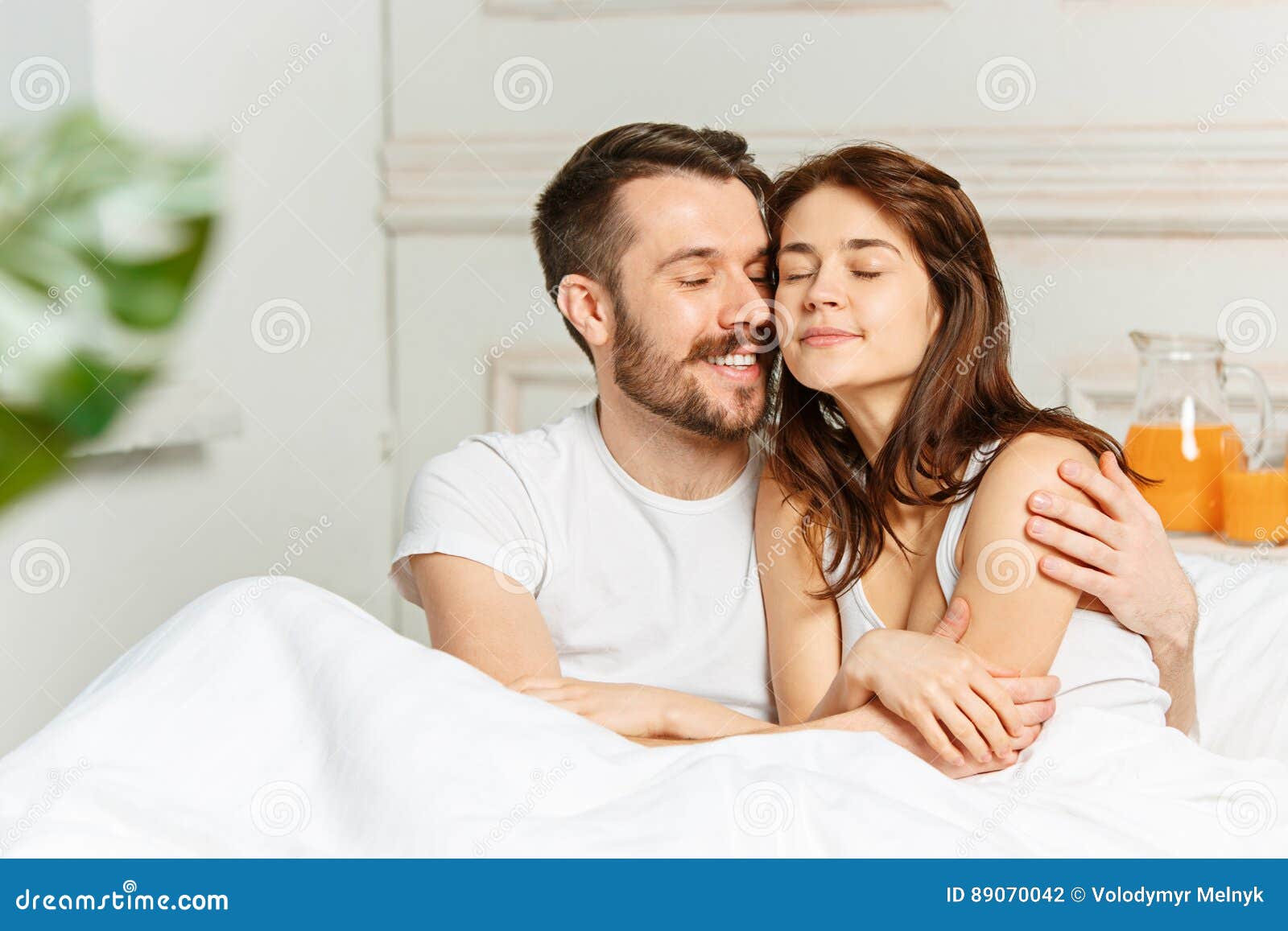 Young Adult Heterosexual Couple Lying On Bed In Bed