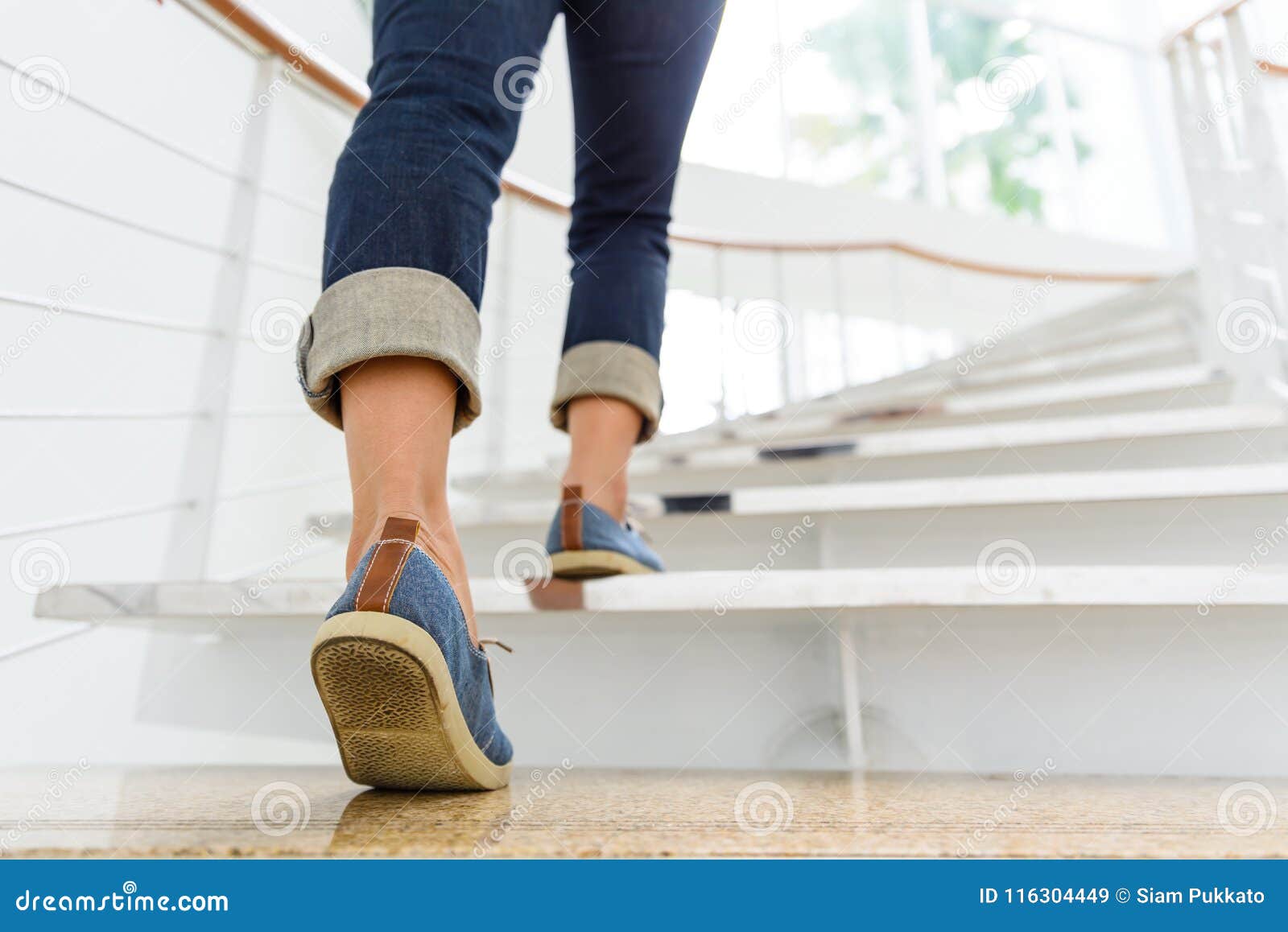 young adult woman walking up the stairs