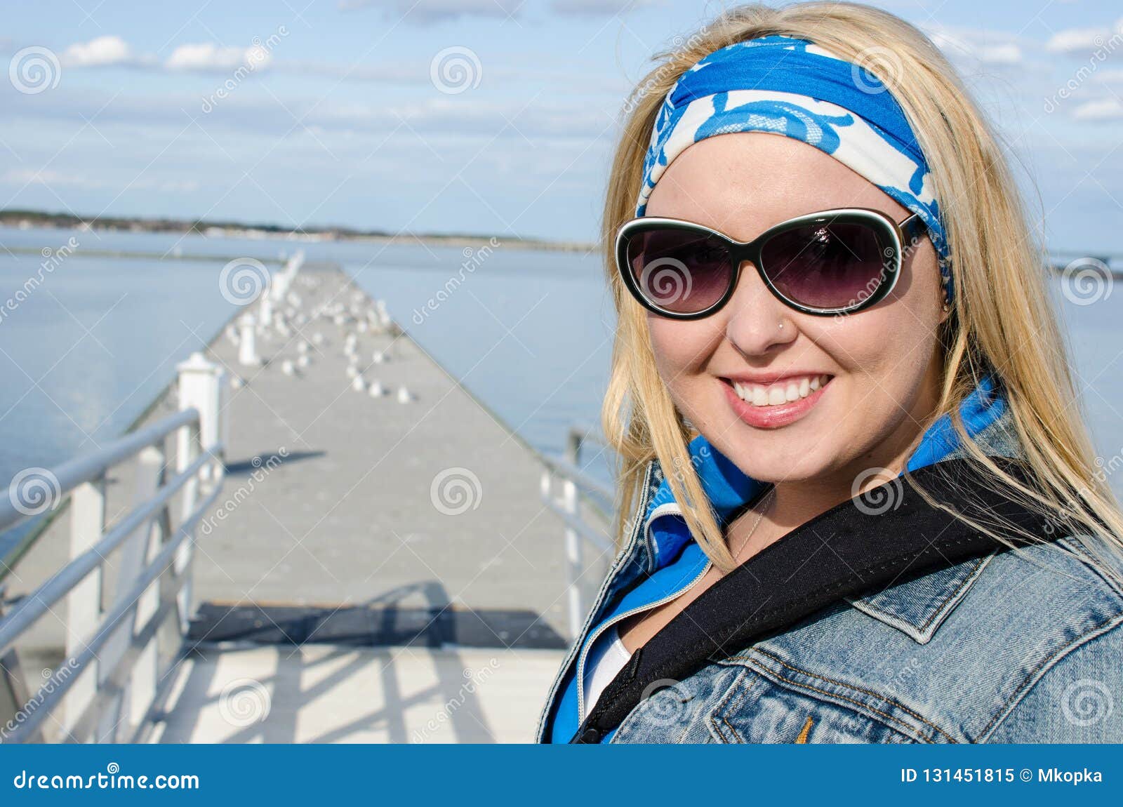young adult woman walks out onto a pier near the choptank river in cambridge maryland on a sunny spring day