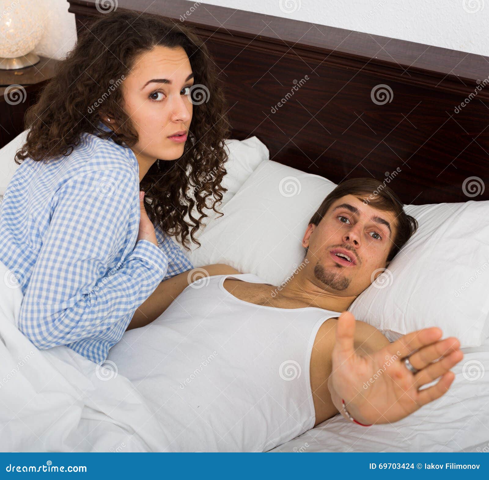 Young Adults Caught Having Sex in Bed Stock Photo
