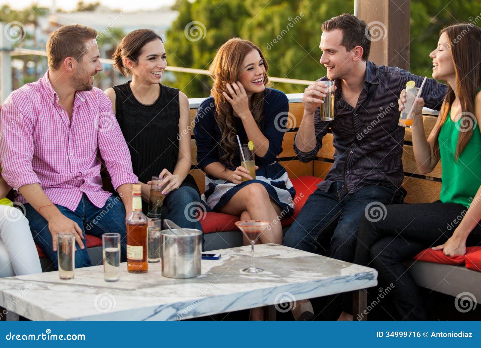 Young Adults Having Drinks At A Bar Stock Photo Image Of Friends