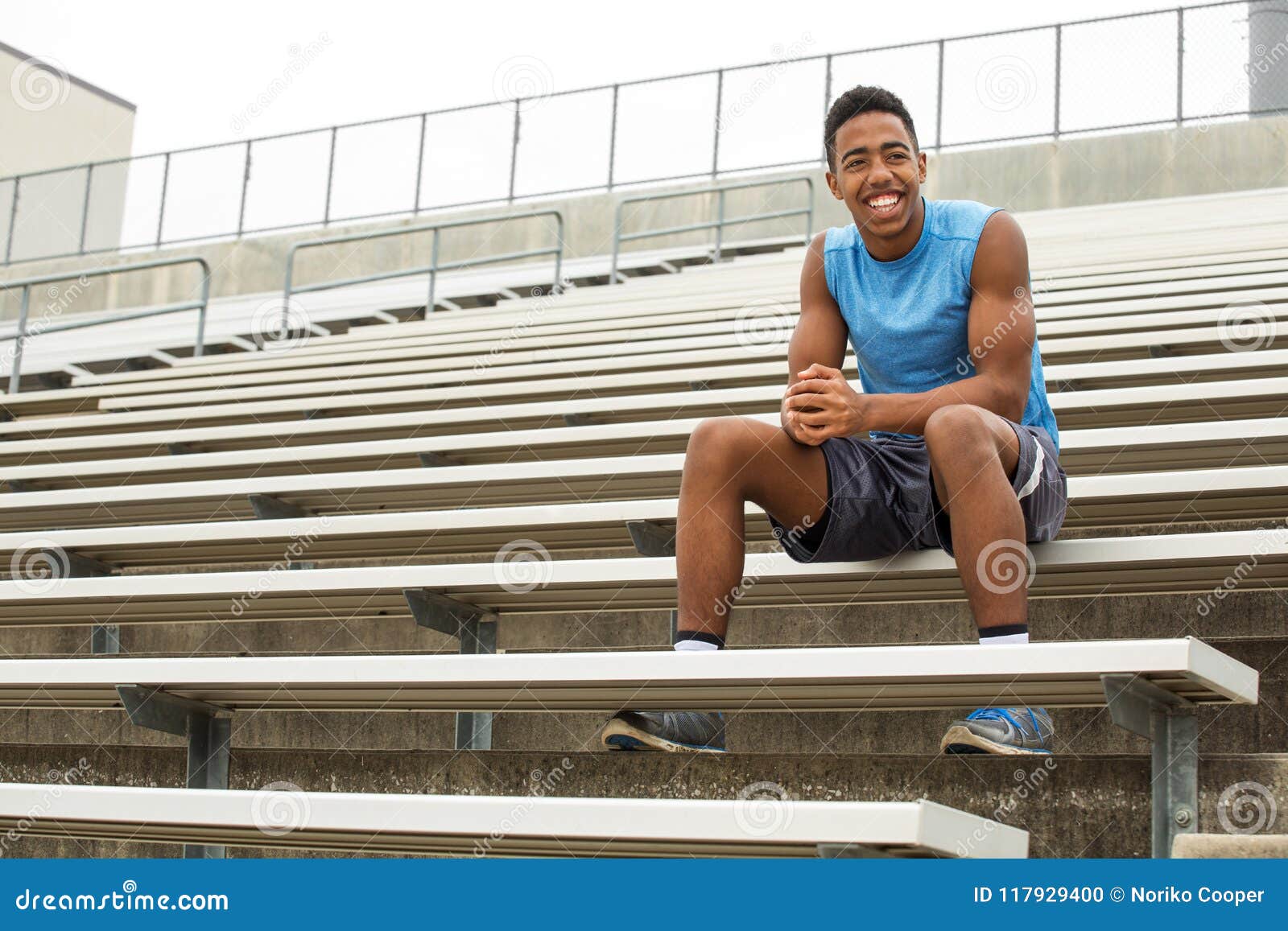 teenage athlete sitting on the bleachers.