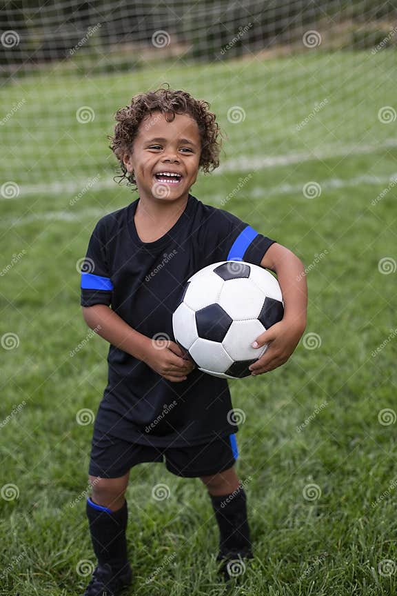 Young African American Soccer Player Standing in Front of a Soccer Goal