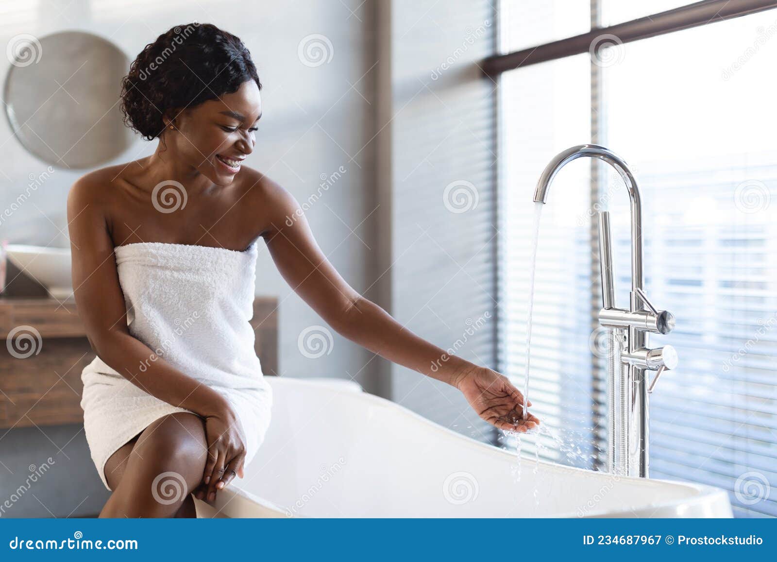 Young Black Woman Preparing To Take a Bath in Bathroom Stock Image