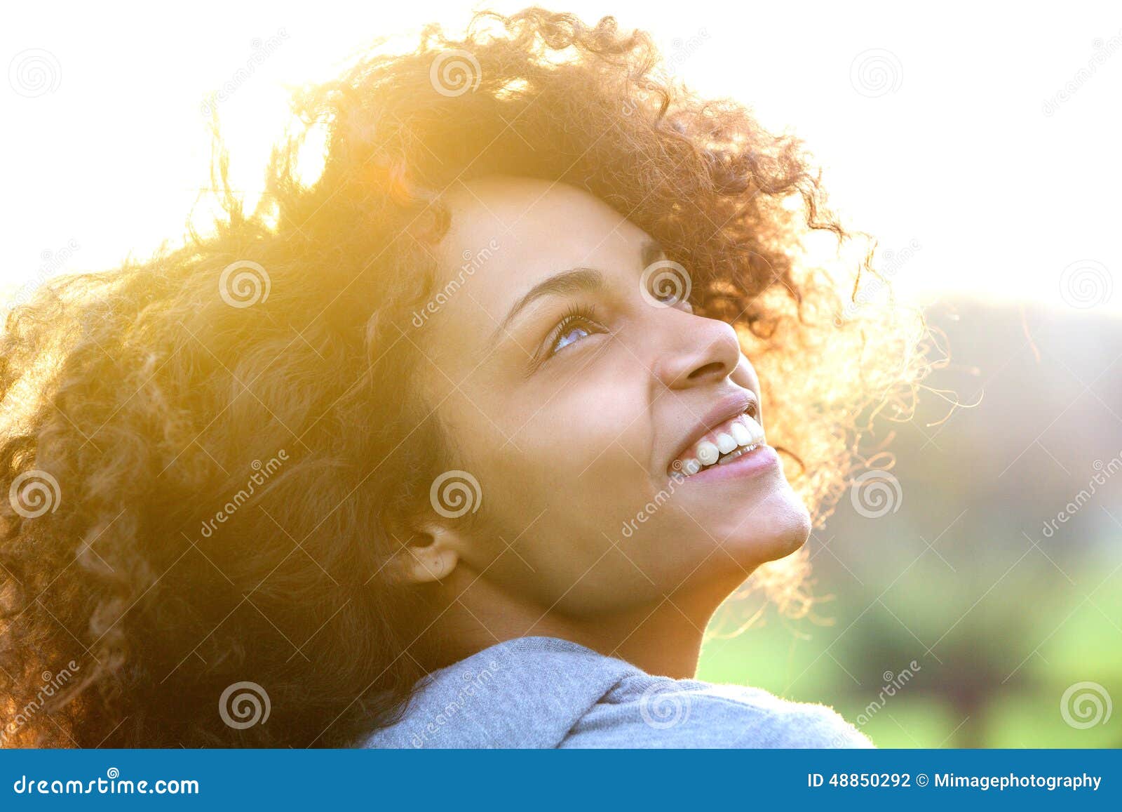 young african american woman smiling and looking up