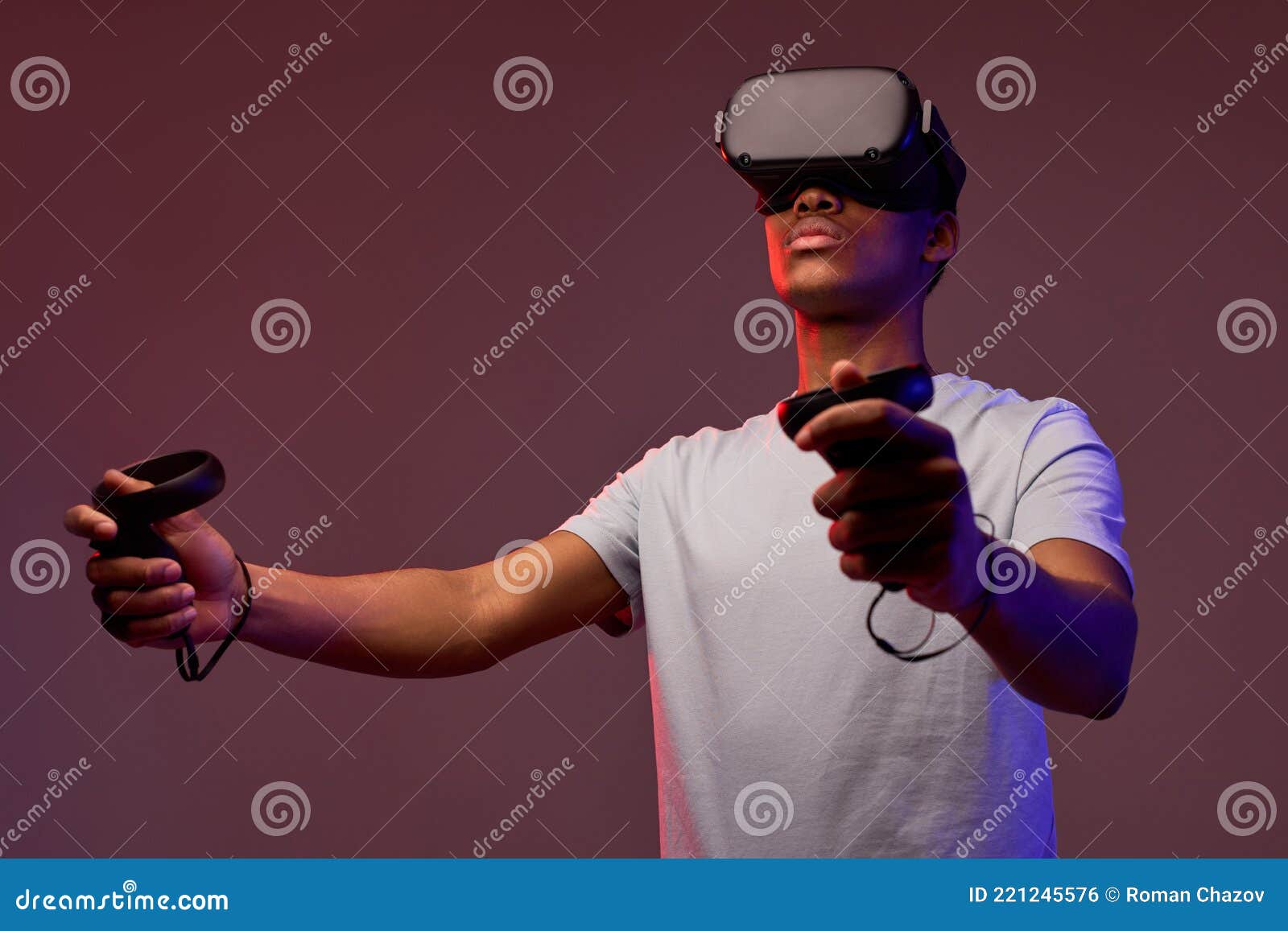 young african boy with virtual reality glasses is playing a videogame,  in studio