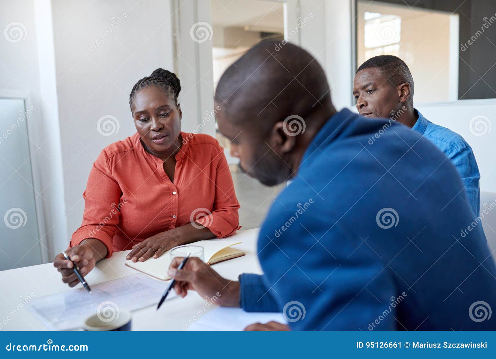 young african business colleagues discussing paperwork in an office