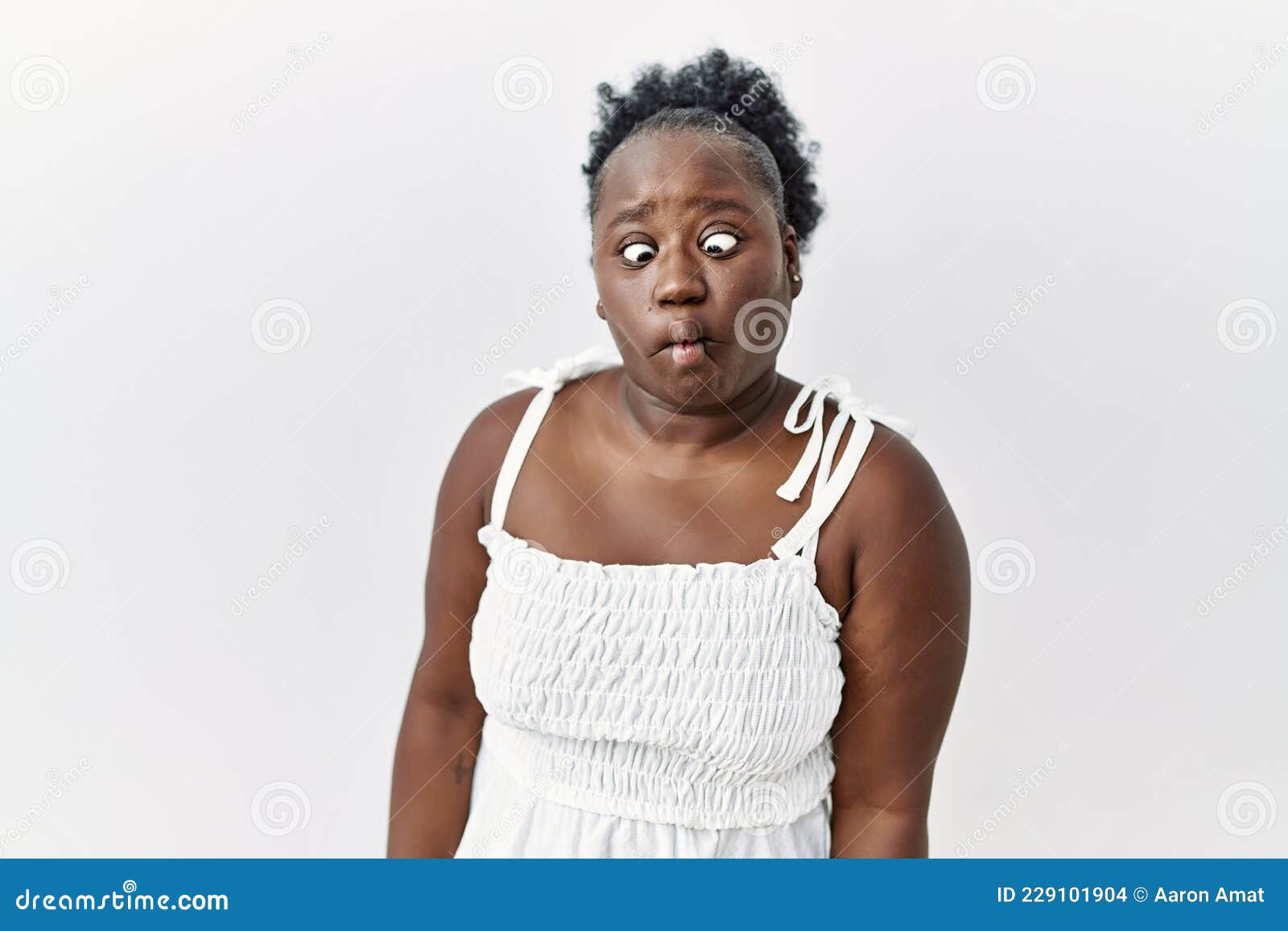 Young African Woman Standing Over White Isolated Background Making Fish Face  with Lips, Crazy and Comical Gesture Stock Photo - Image of fish, isolated:  229101904