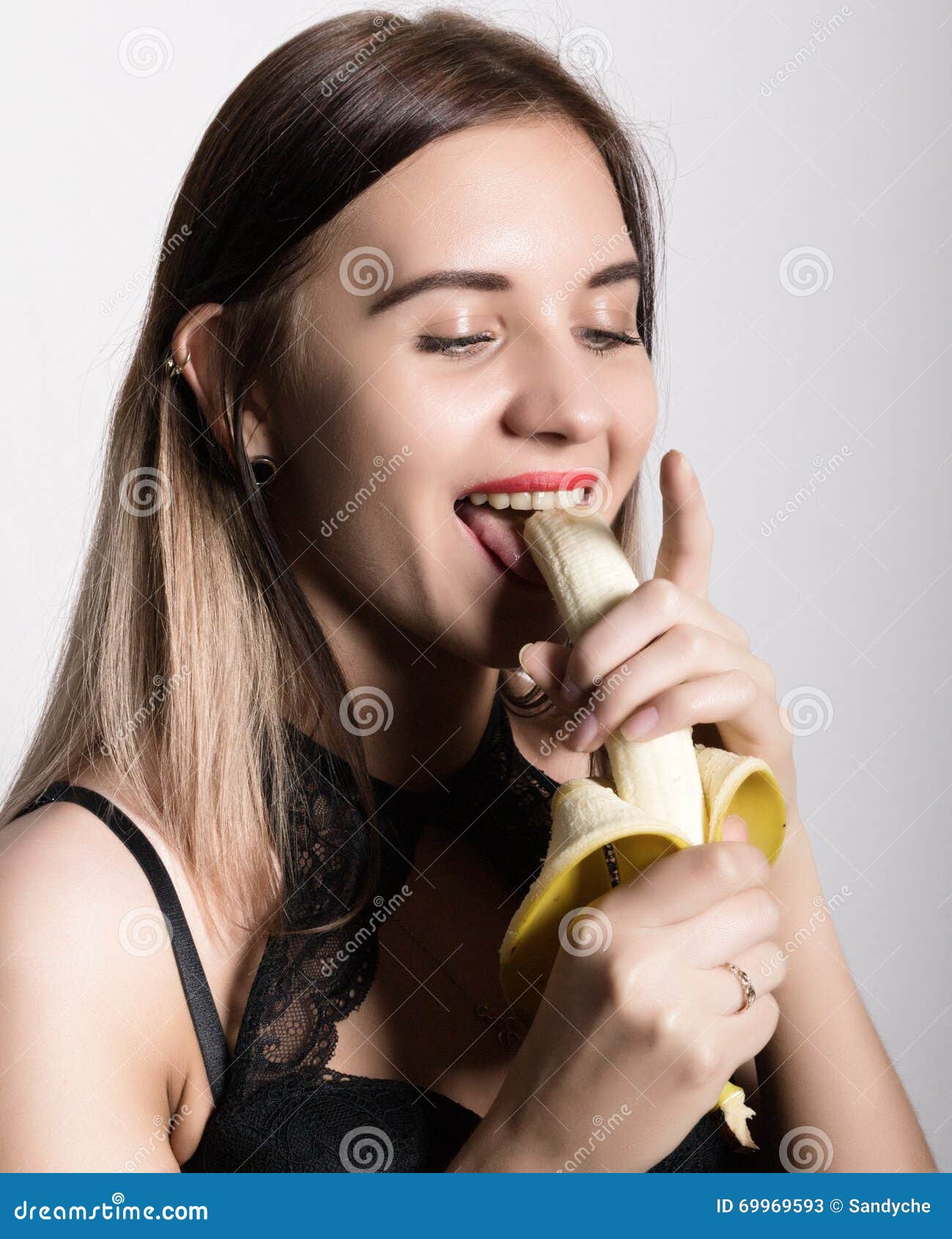 Young Amazed Woman In Lacy Lingerie Holding A Banana Sh