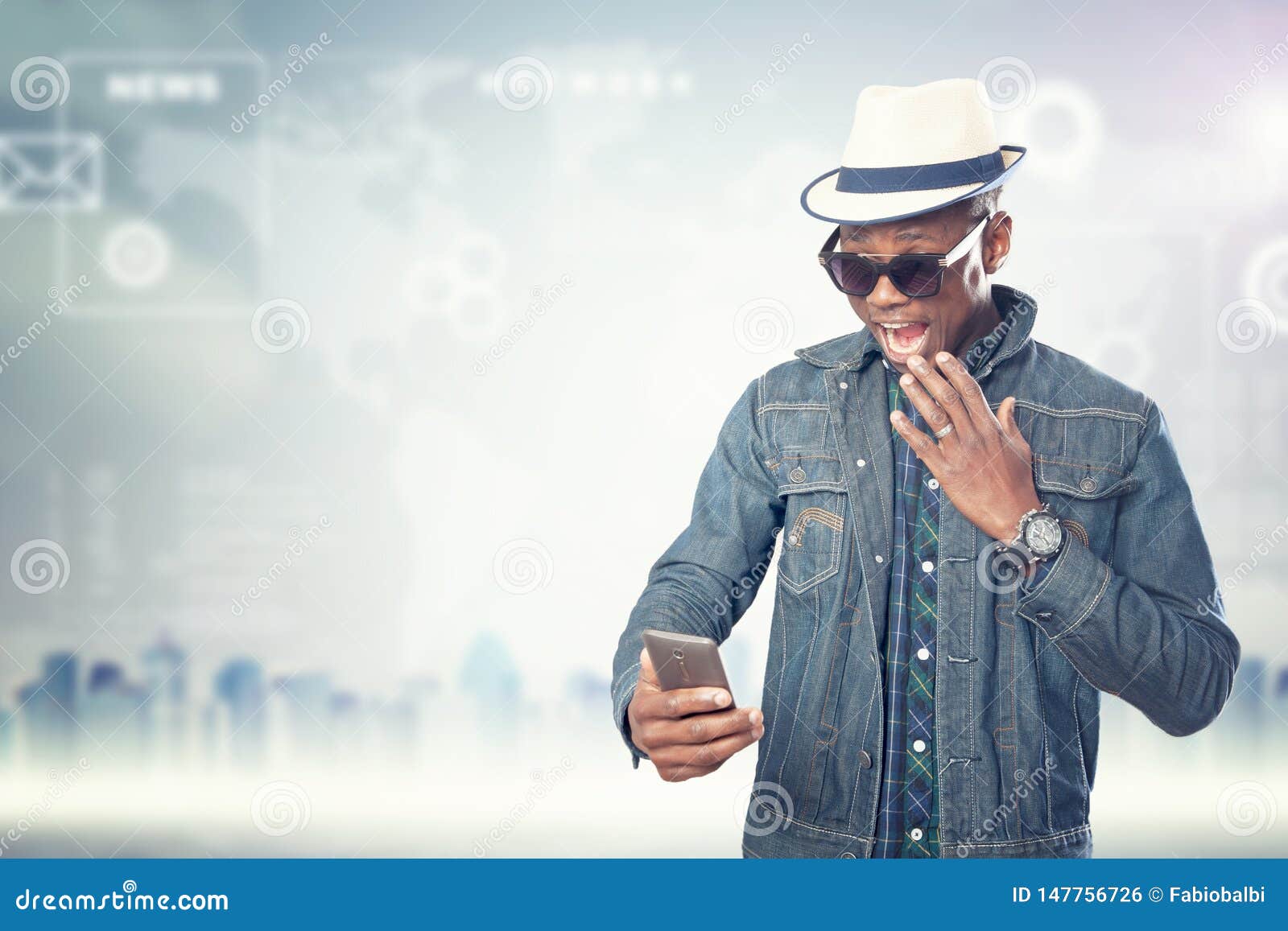 Young American African Guy with Cell Phone. Handsome Man Stock Photo