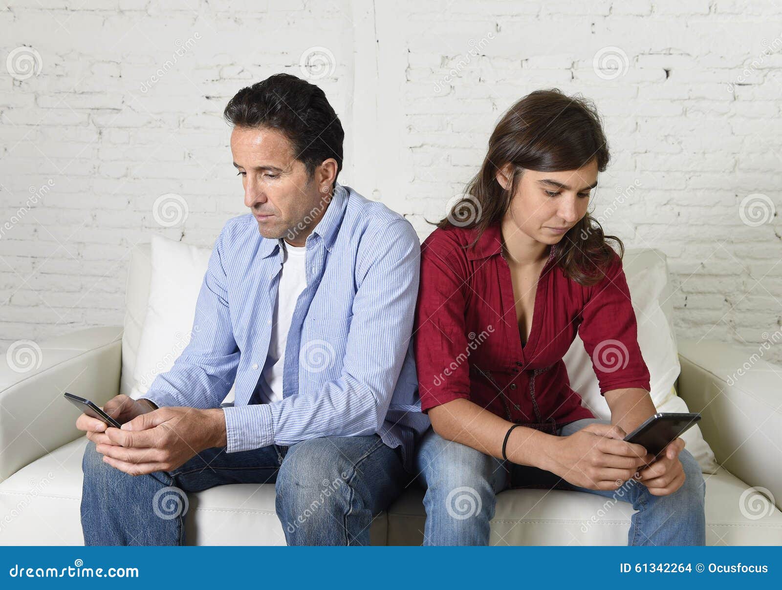 young antisocial mobie phonel addict couple ignoring each other using internet compulsively