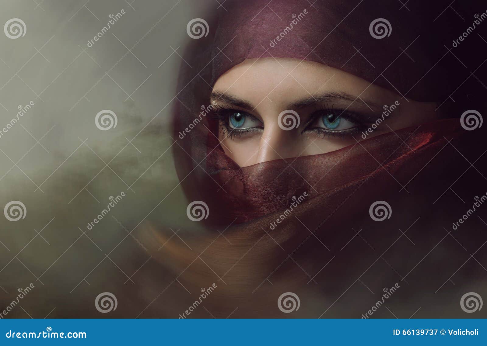 young arabian woman in hijab with blue eyes