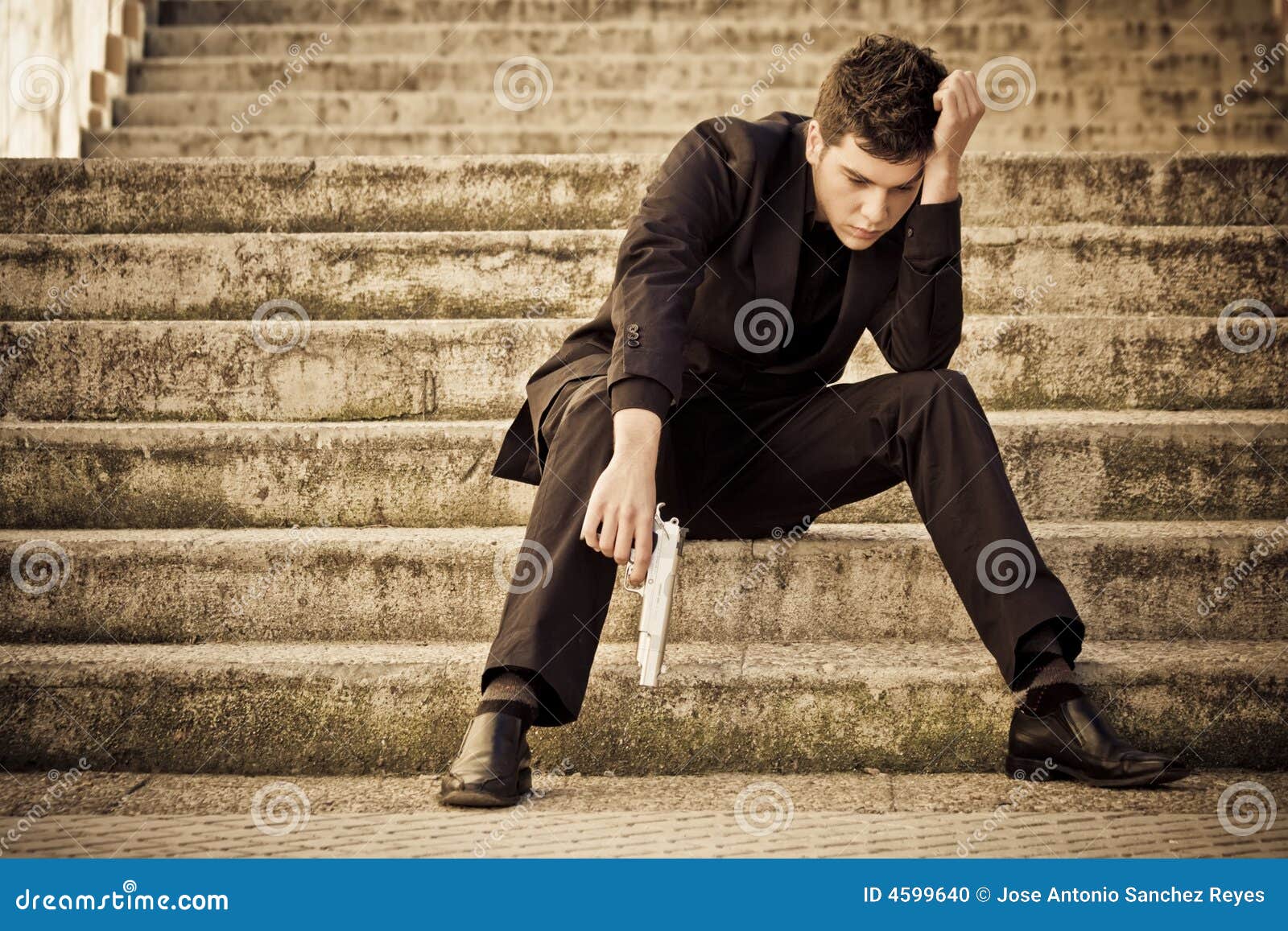 young armed man on stairs