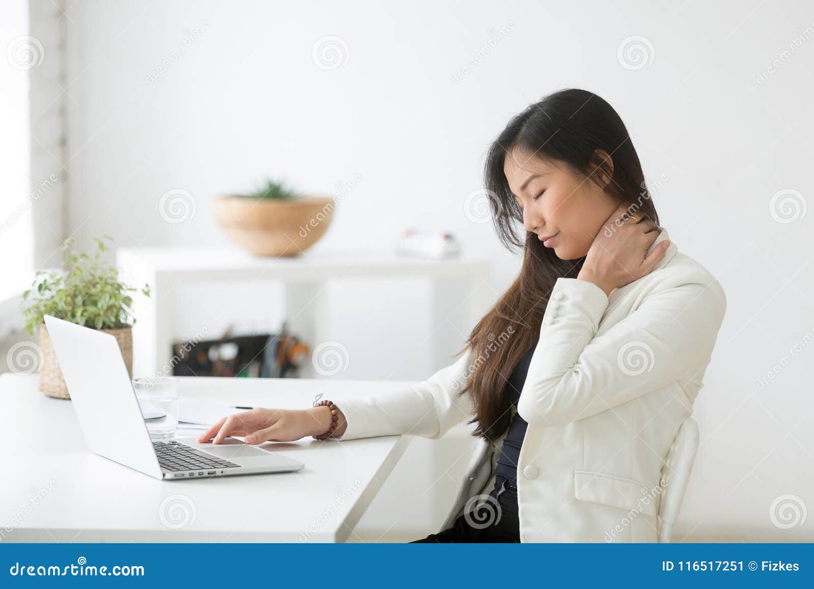 young asian businesswoman feels neck pain after sedentary comput