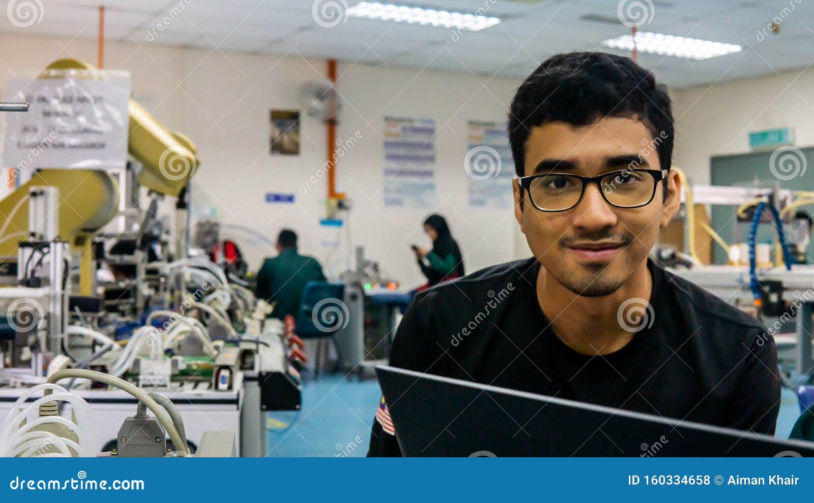 A Young Asian Engineering Student with Spectacles Smiling. Stock Photo