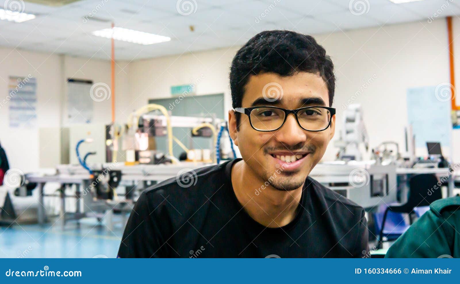 A Young Asian Engineering Student with Spectacles Smiling. Stock Photo