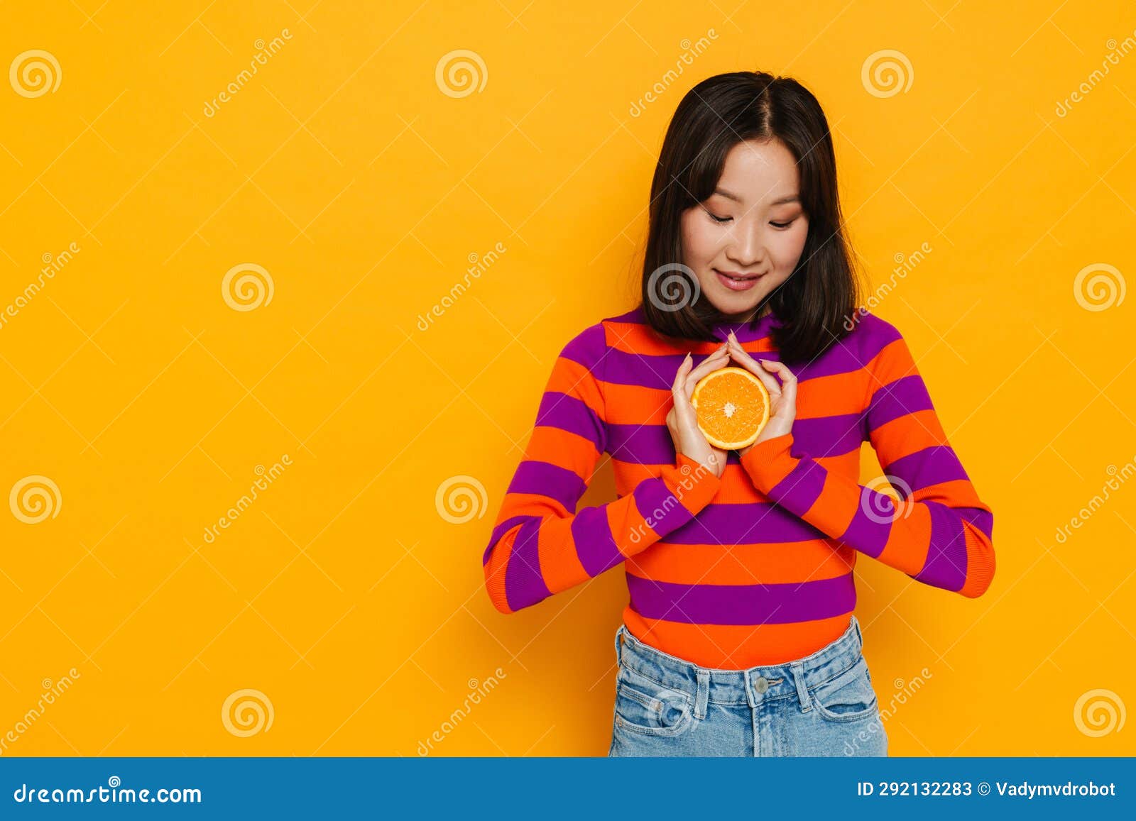Asian Girl Posing With Sliced Orange While Standing Over Isolated Stock Image Image Of Asian 