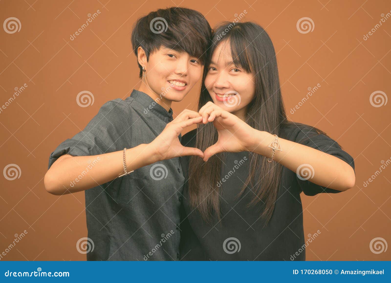 Young Asian Lesbian Couple Together And In Love Against Br