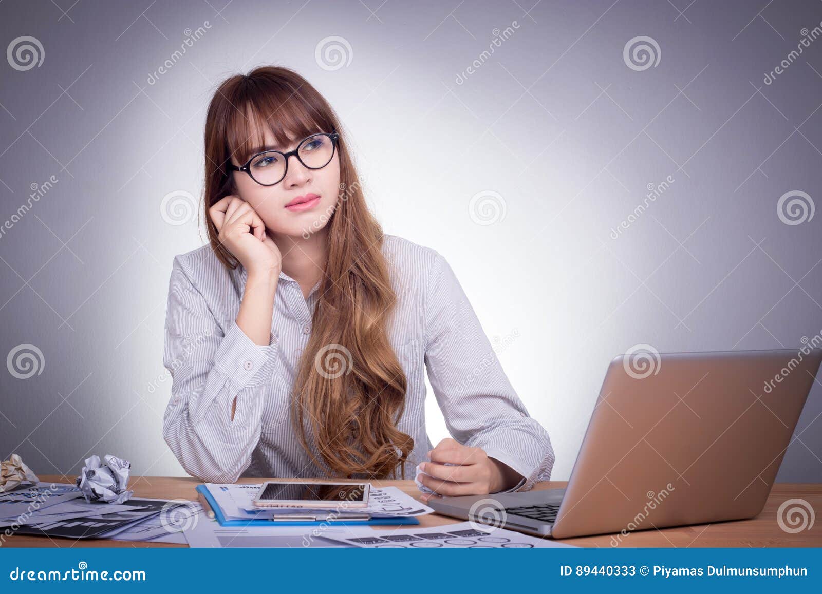 Young Asian Office Woman At A Modern Office Desk Working With