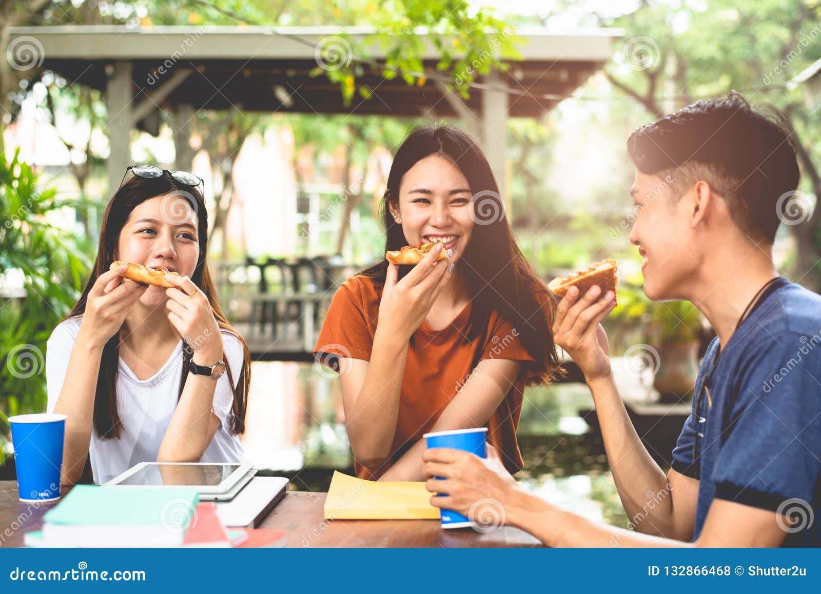 young asian people eating pizza together by hands. food and friendship celebration party concept. lifestyles and people in theme.