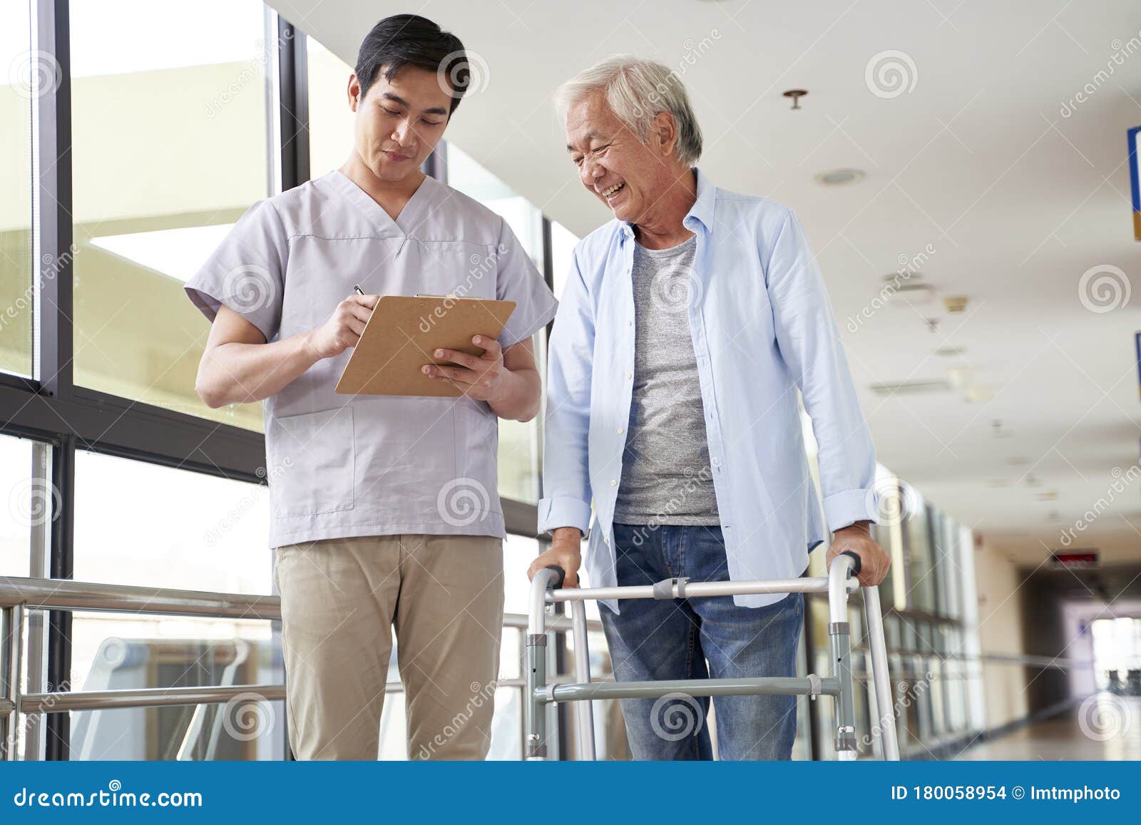 Young Asian Physical Therapist Working with Old Man Stock Photo Image