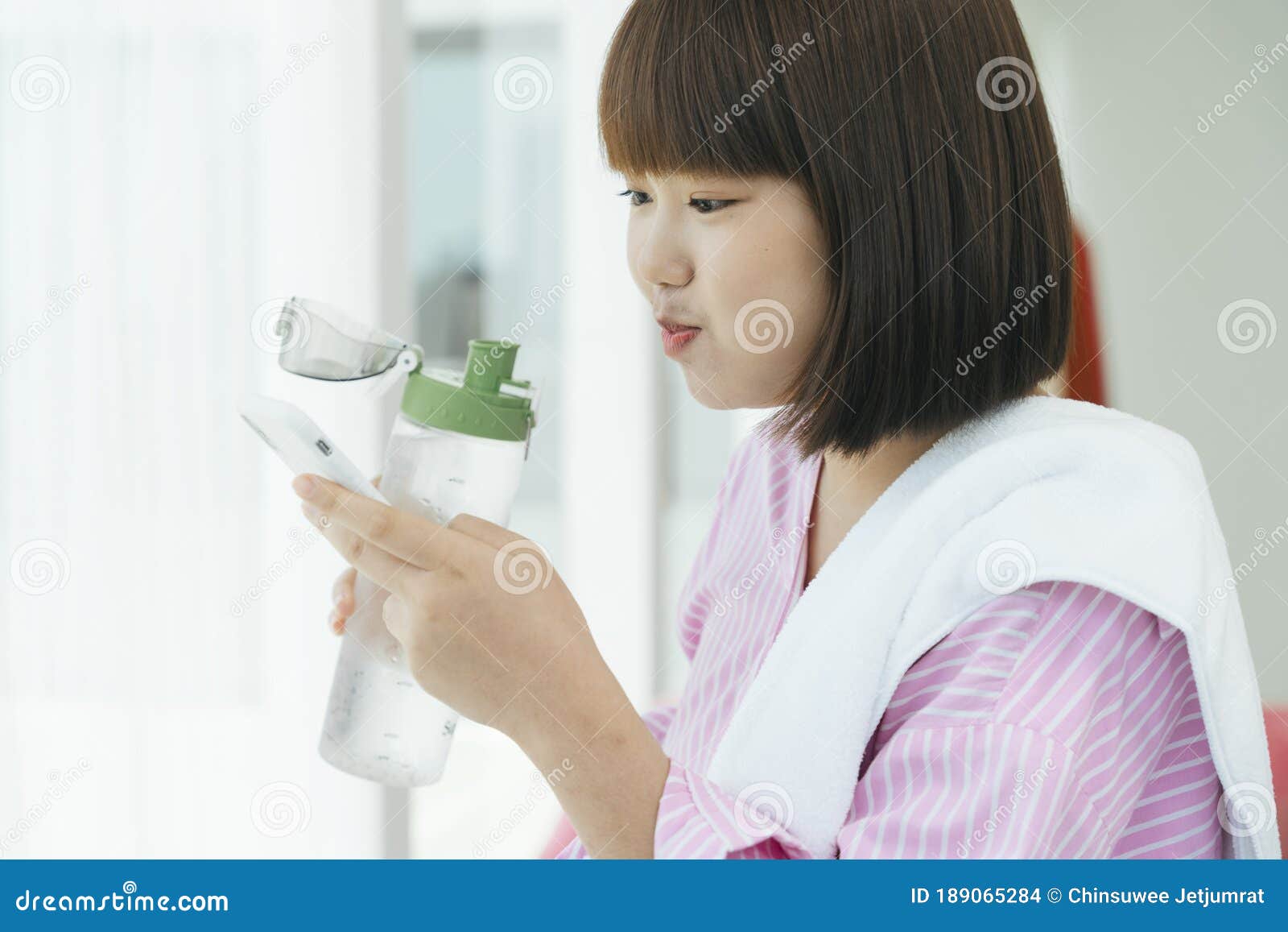 Young Asian Thai Short Hair Bob Hairstyle Drinking Water From Bottle And Using Smartphone Stock Photo Image Of Lifestyle Morning 189065284