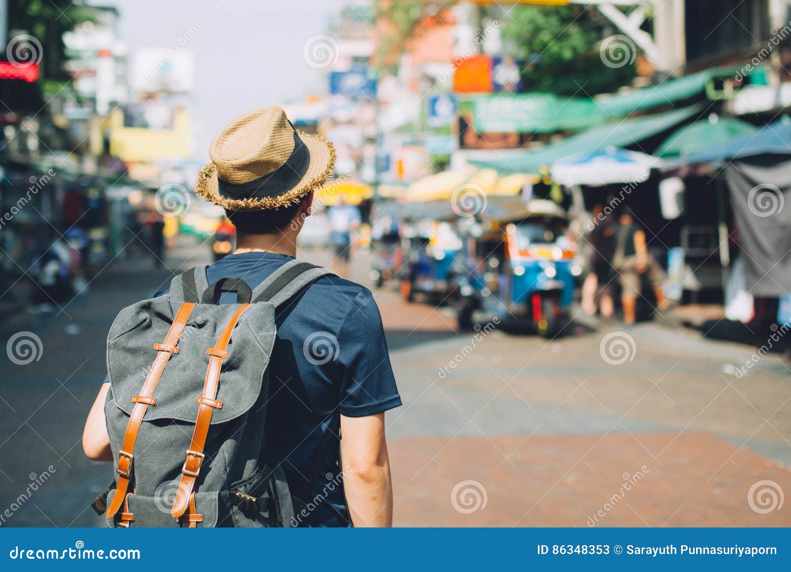 young asian traveling backpacker in khaosan road outdoor market