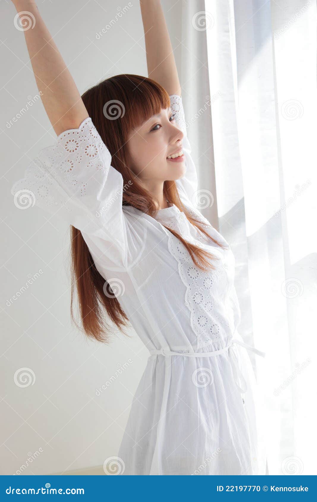 Beautiful young Asian woman by the window