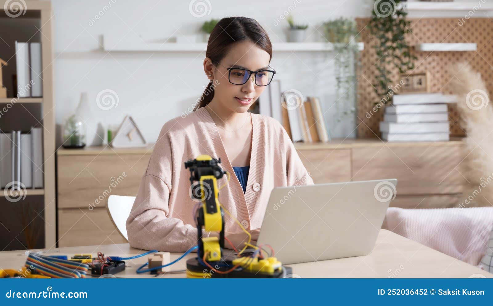 young asian woman engineer programer working on robotics project at home.