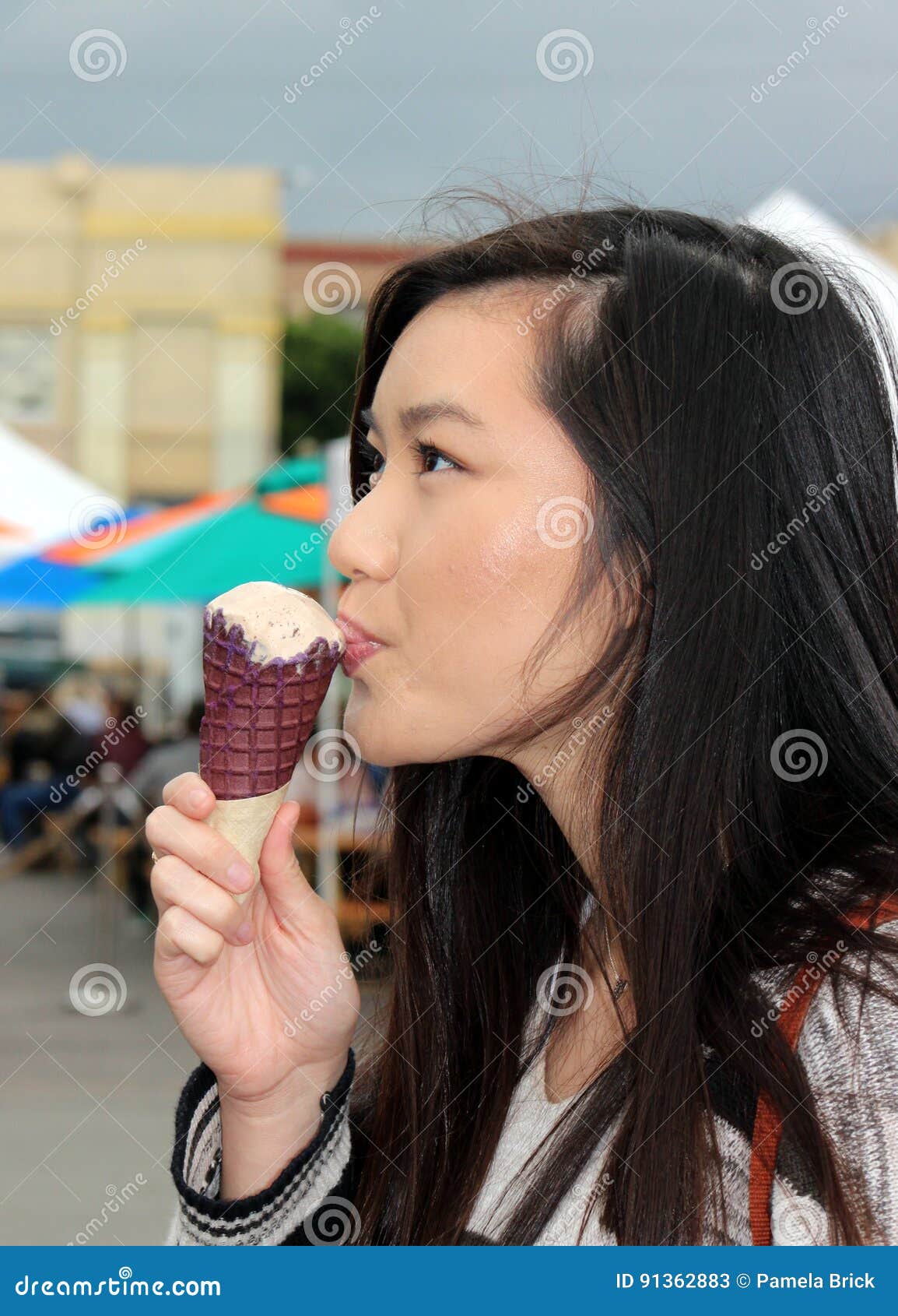 Young Asian Woman Enjoys An Ice Cream Cone Indulgence Stock Image