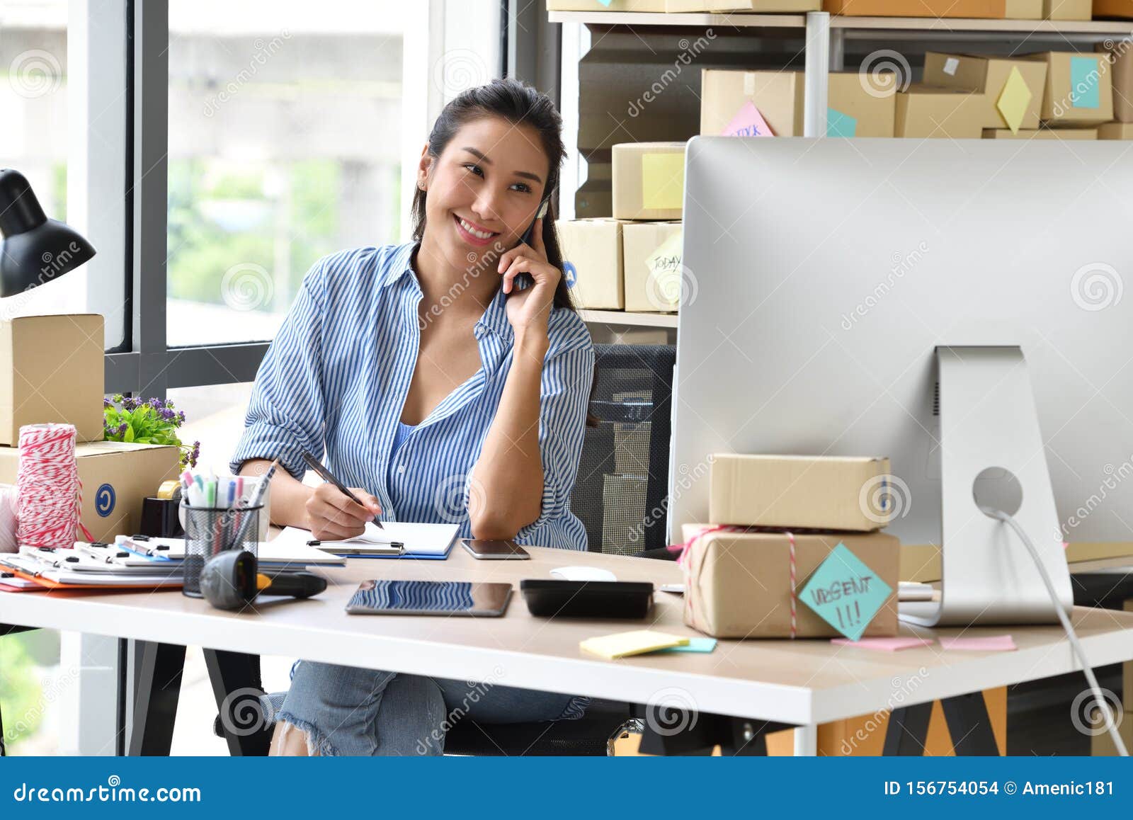 young asian woman entrepreneur/ business owner working with computer at home