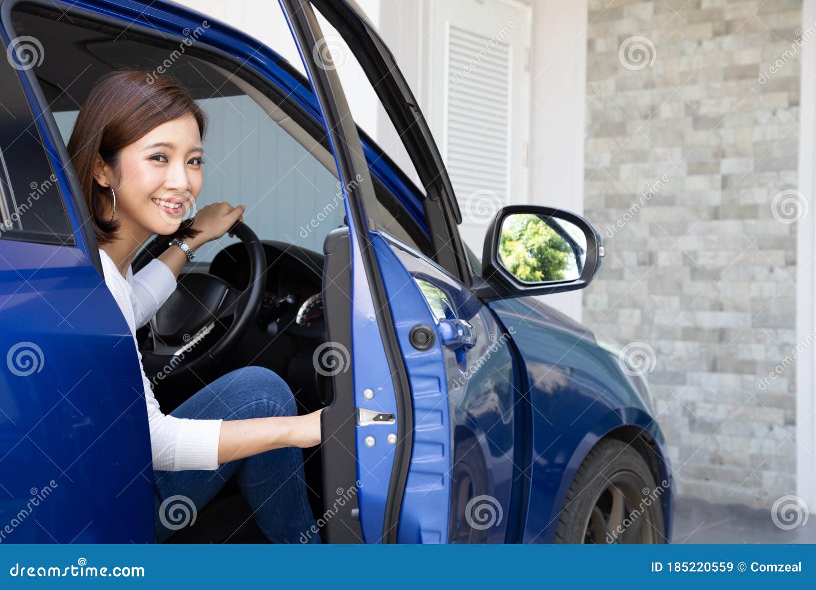 young asian woman getting out of a car or open door car.