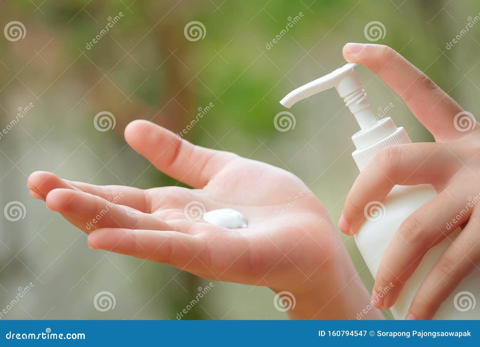 young asian woman hands holding body lotion bottle and using cream for treatment skin in winter time.
