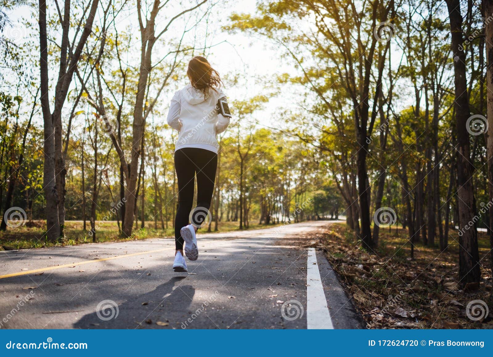 A Young Asian Woman Jogging in City Park in the Morning Stock Photo ...