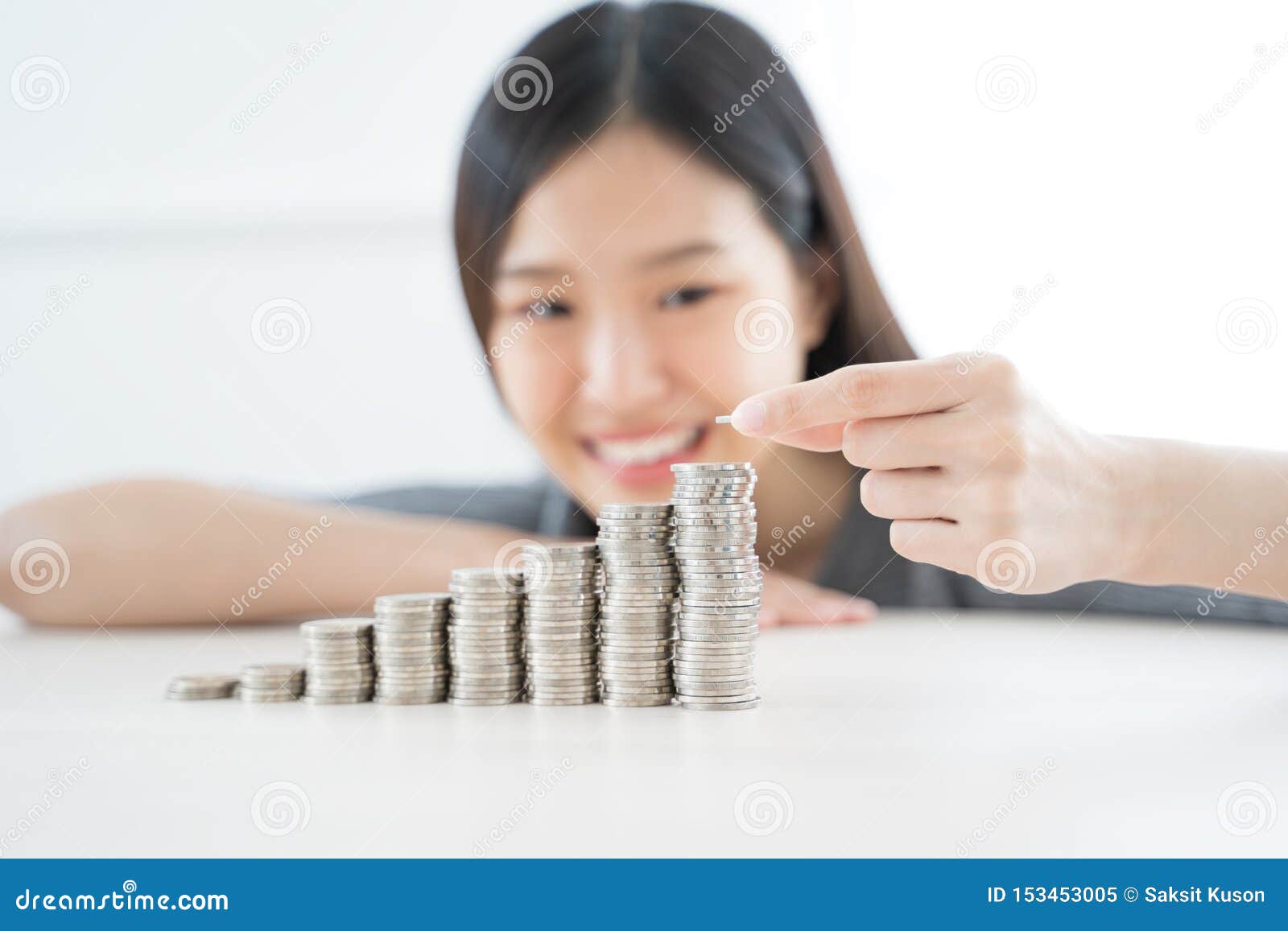 young asian woman making stack of coins. invest save finance concept.