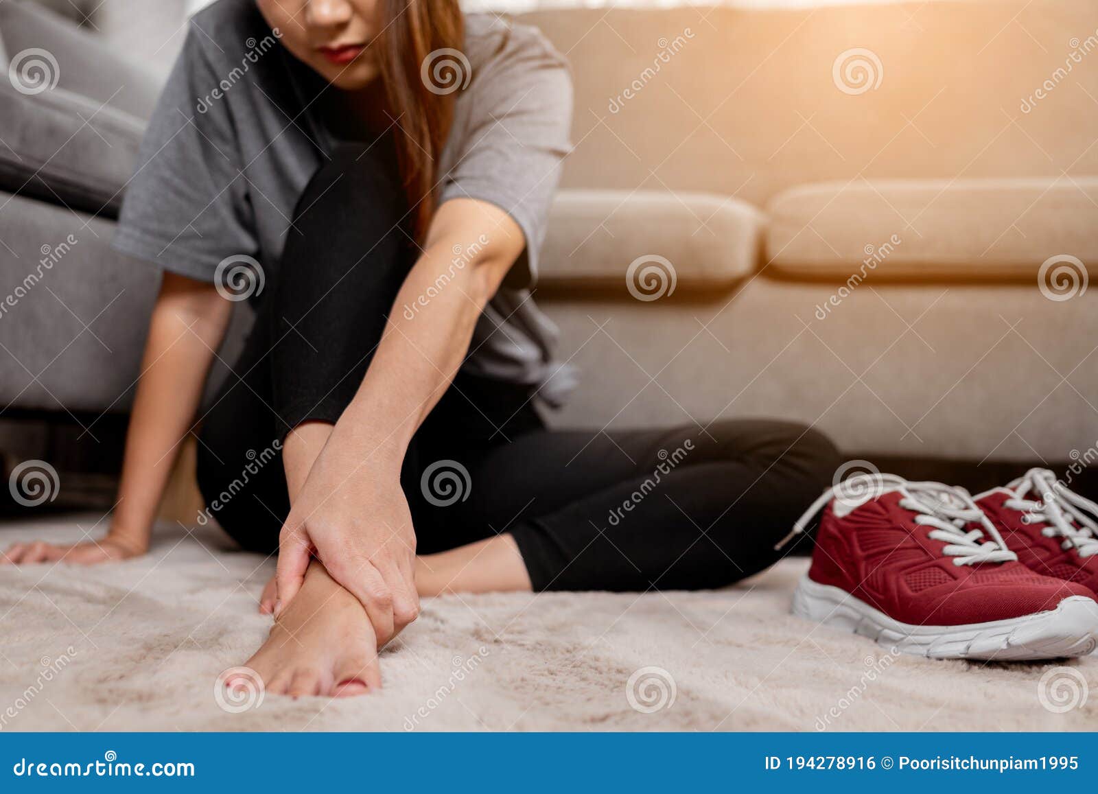 Young Asian Woman Massaging Her Pain Of Foot After Exercise Stock Phot