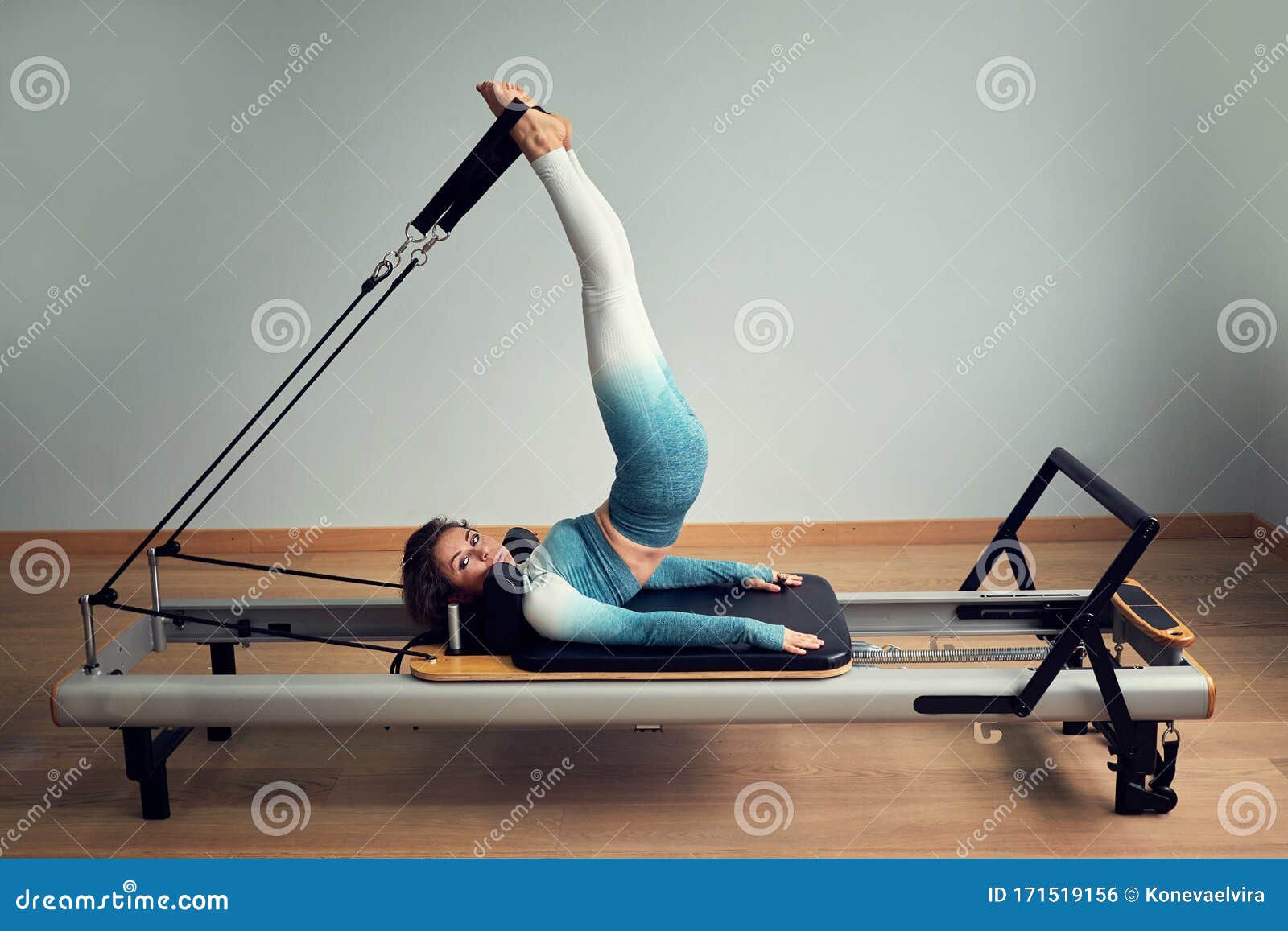 Young Asian Woman Pilates Stretching Sport in Reformer Bed