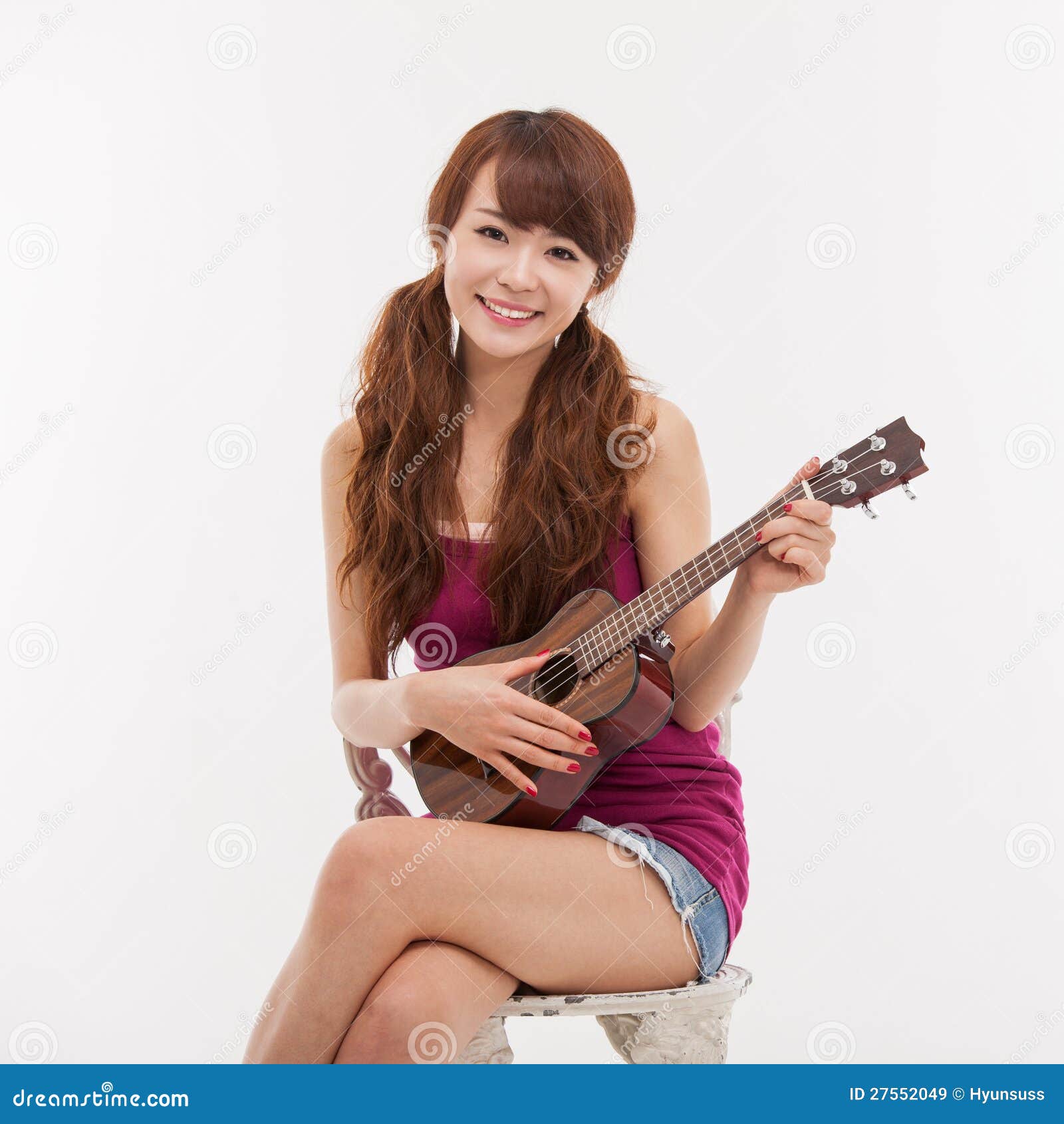 Young Asian Woman Playing Ukulele. Royalty Free Stock Images Image