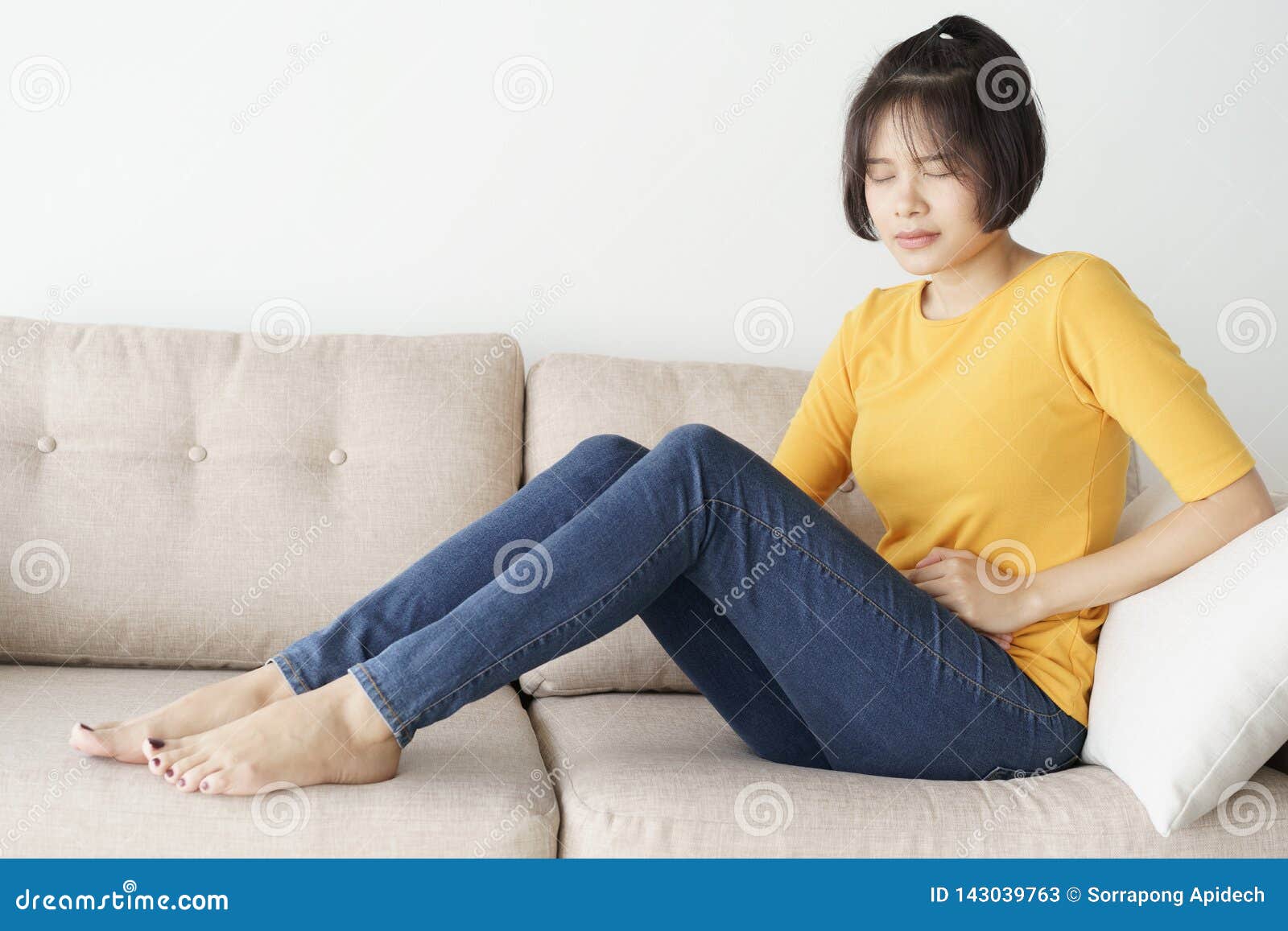 Young Asian Woman Sit On Sofa In The Living Room She Having Painful
