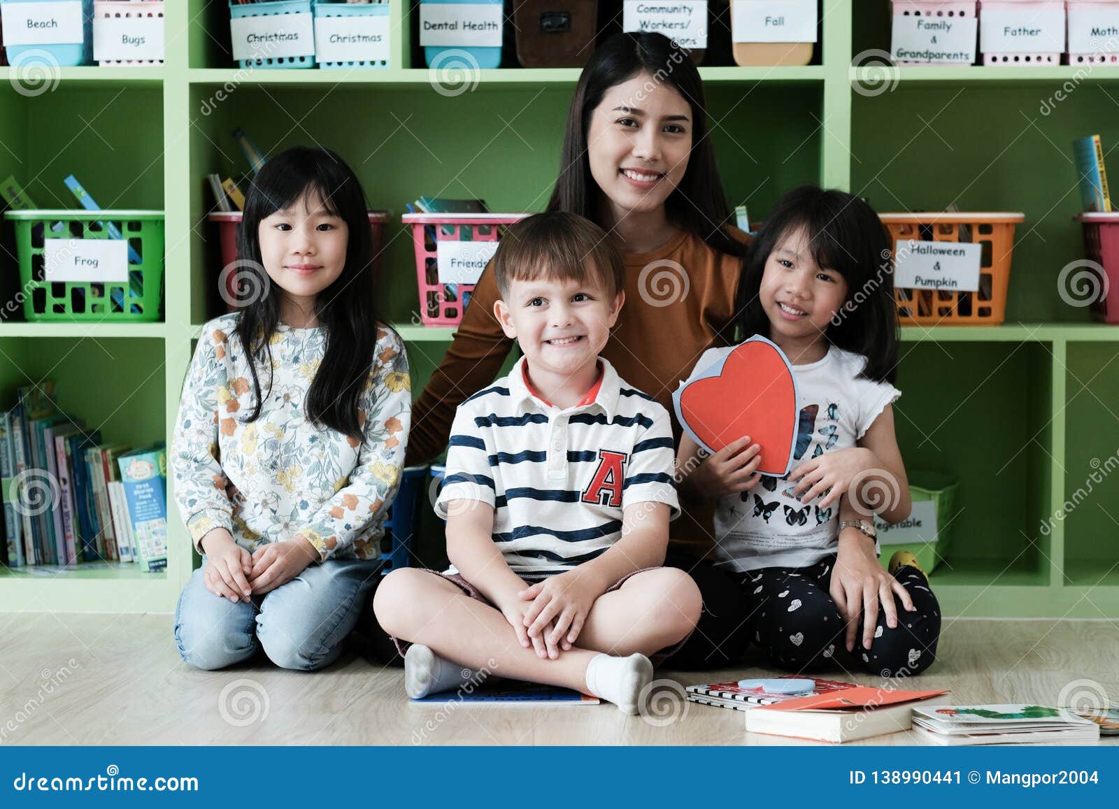 Young Asian Woman Teacher Teaching Kids In Kindergarten