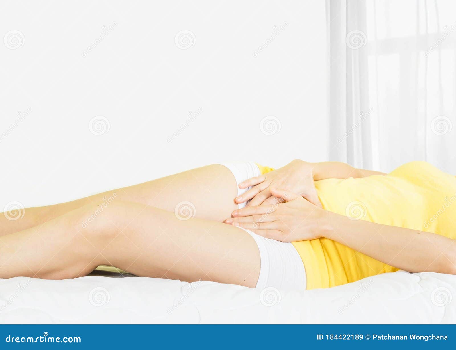 Tiny Little Asian Pussy - Young Asian Woman Wearing Yellow Undershirt Sitting on a White Bed by the  Window with a Thin Curtain Female Holding Hand To Crotch Stock Image -  Image of illness, ache: 184422189